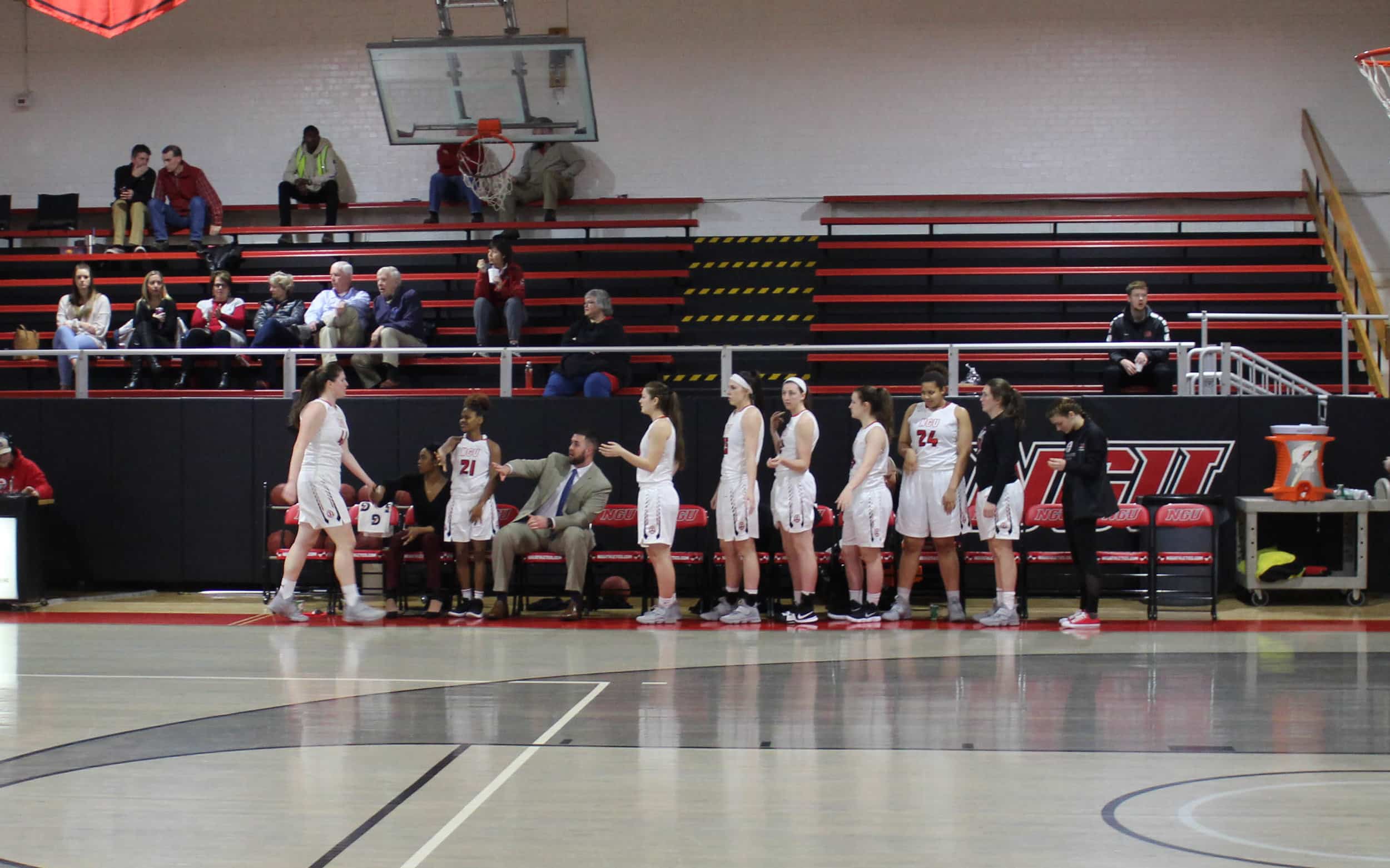 Natalie Averetts (41) fellow team members high five her as she returns to the bench after she made some great plays in the game.