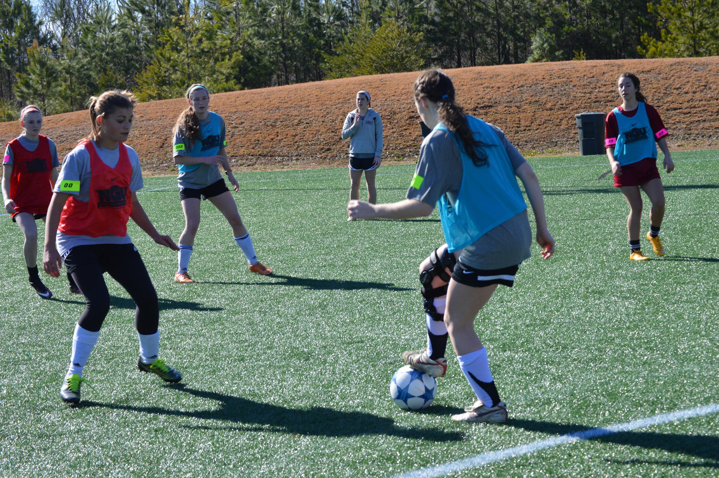 The main goal for the student with the ball was to find a way to score for her team.