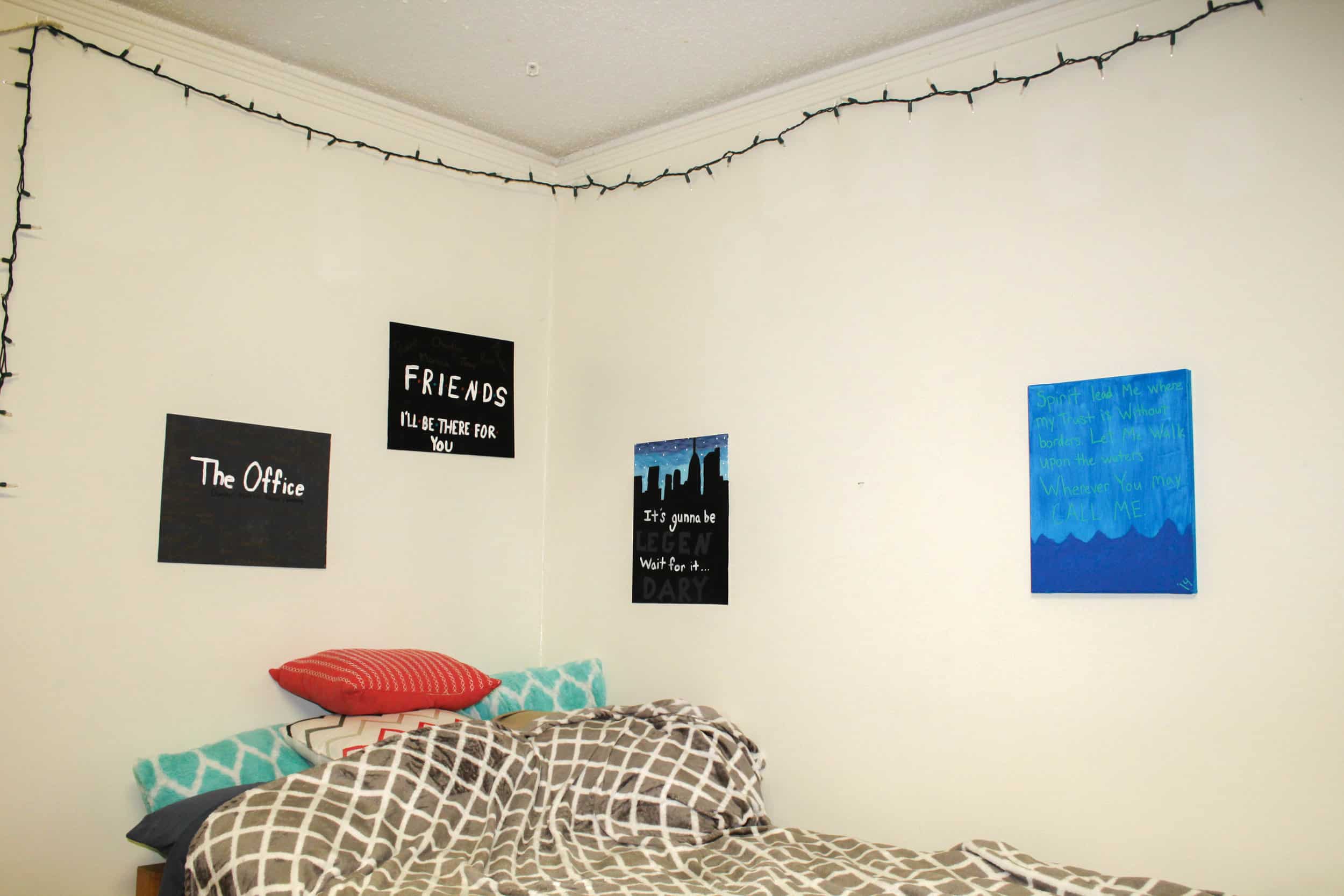 Kayla Gibson, senior, shows her love for multiple TV shows by hanging painted canvases in her room displaying their titles.