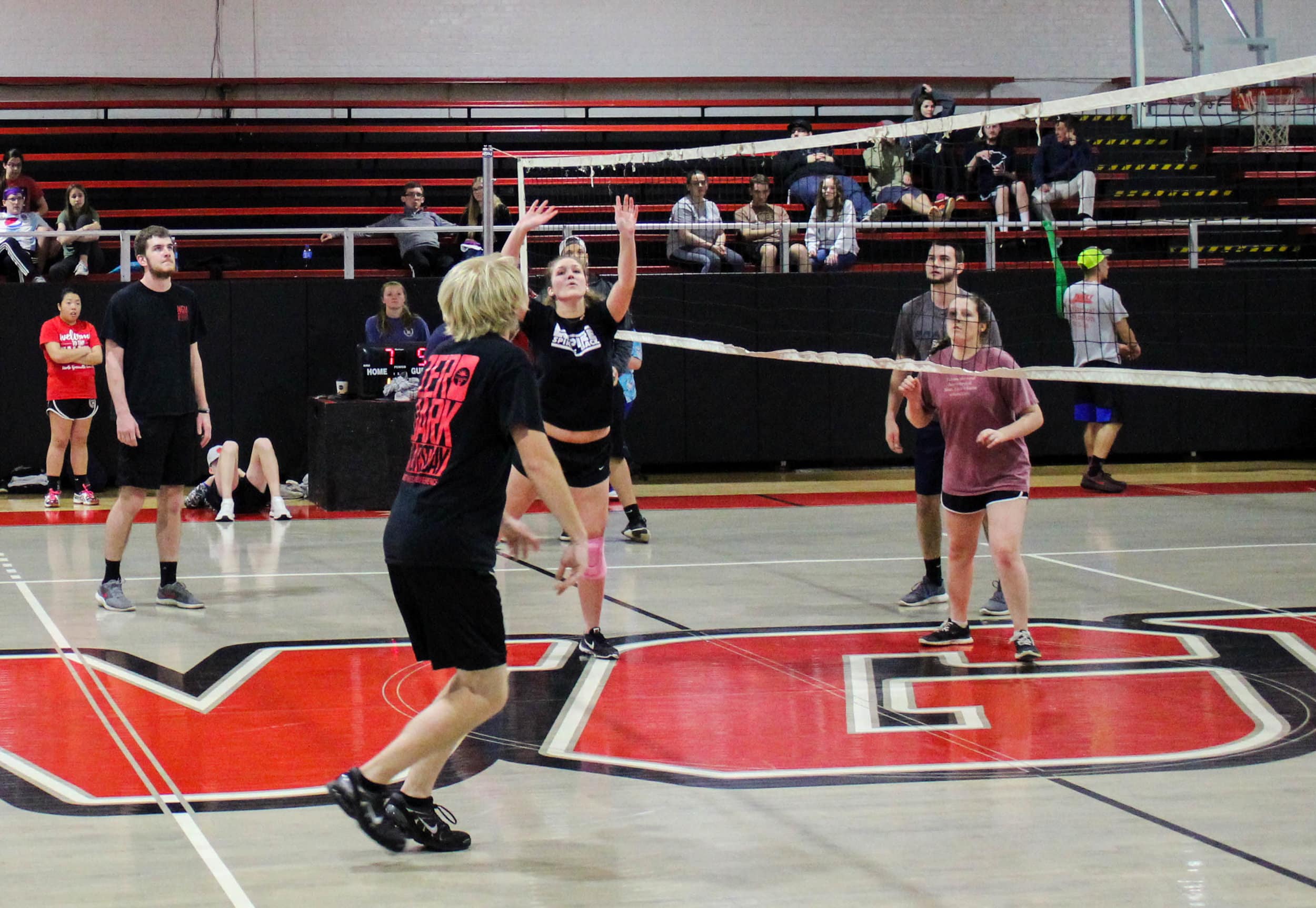 A player from The Empire Spikes Back prepares to set to ball to her teammate.