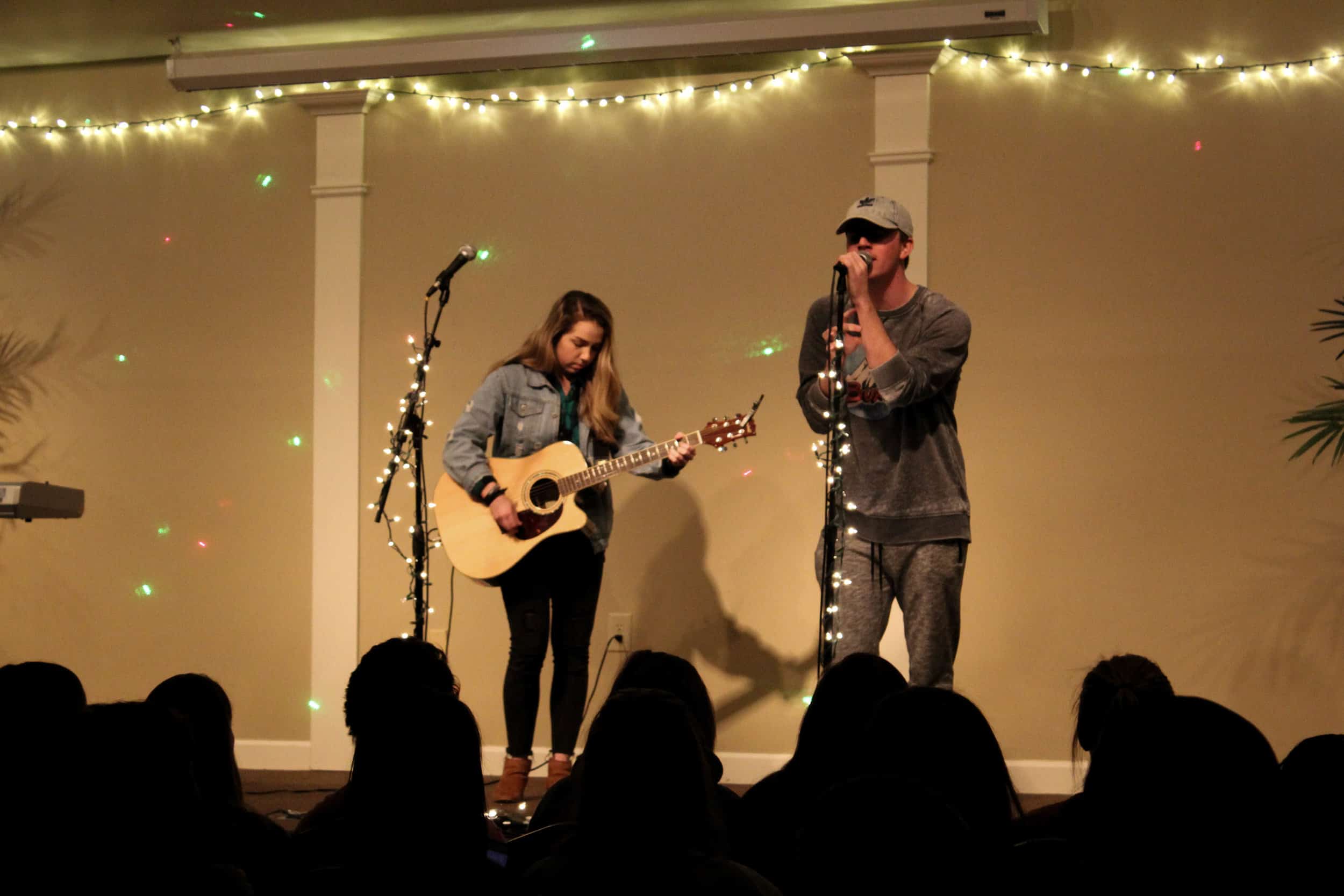 As Katelyn Carter plays the guitar, she and Nick Boggs sing together.