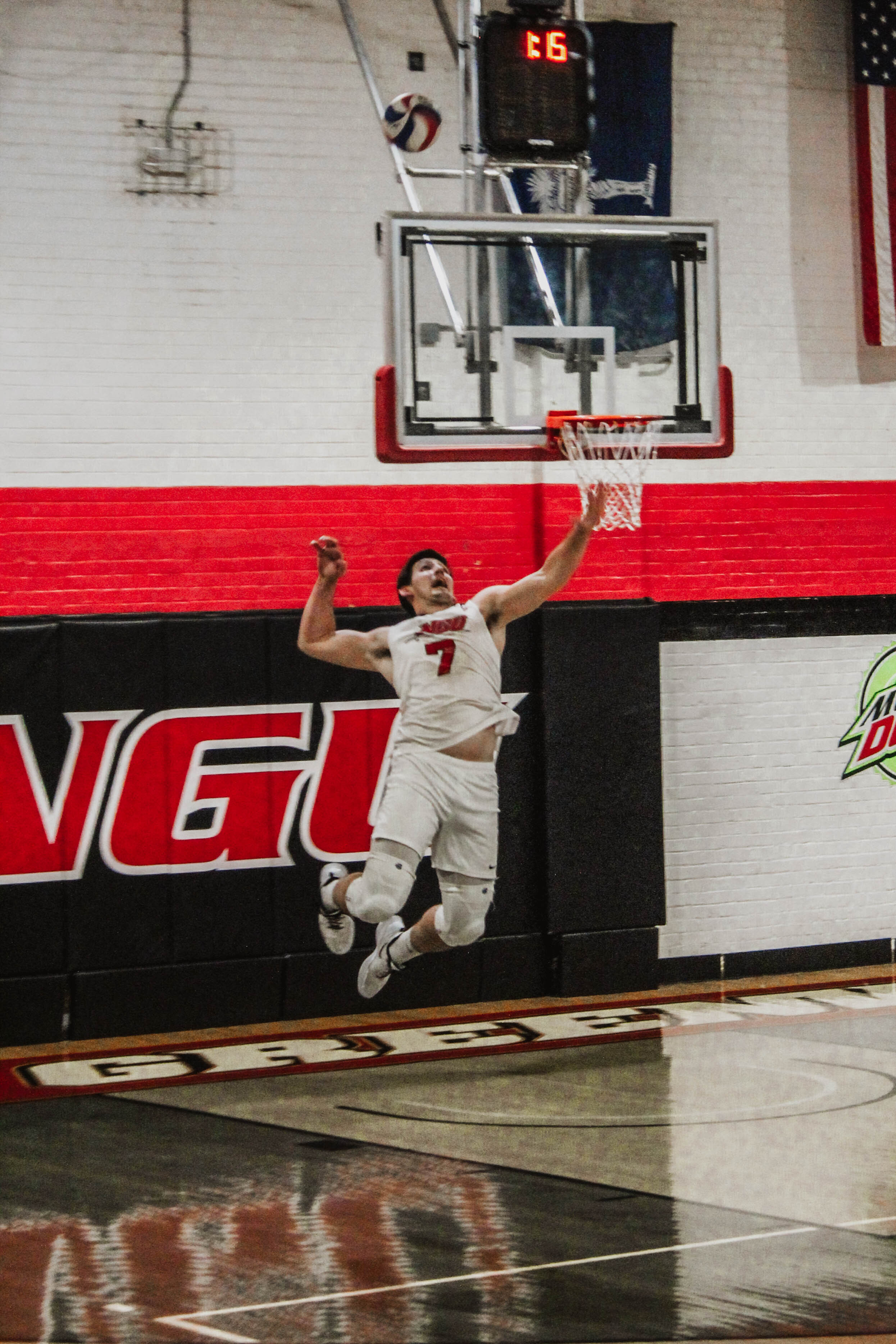 Jackson Gilbert (7), a senior Crusader, serves the ball, scoring a Crusader point.