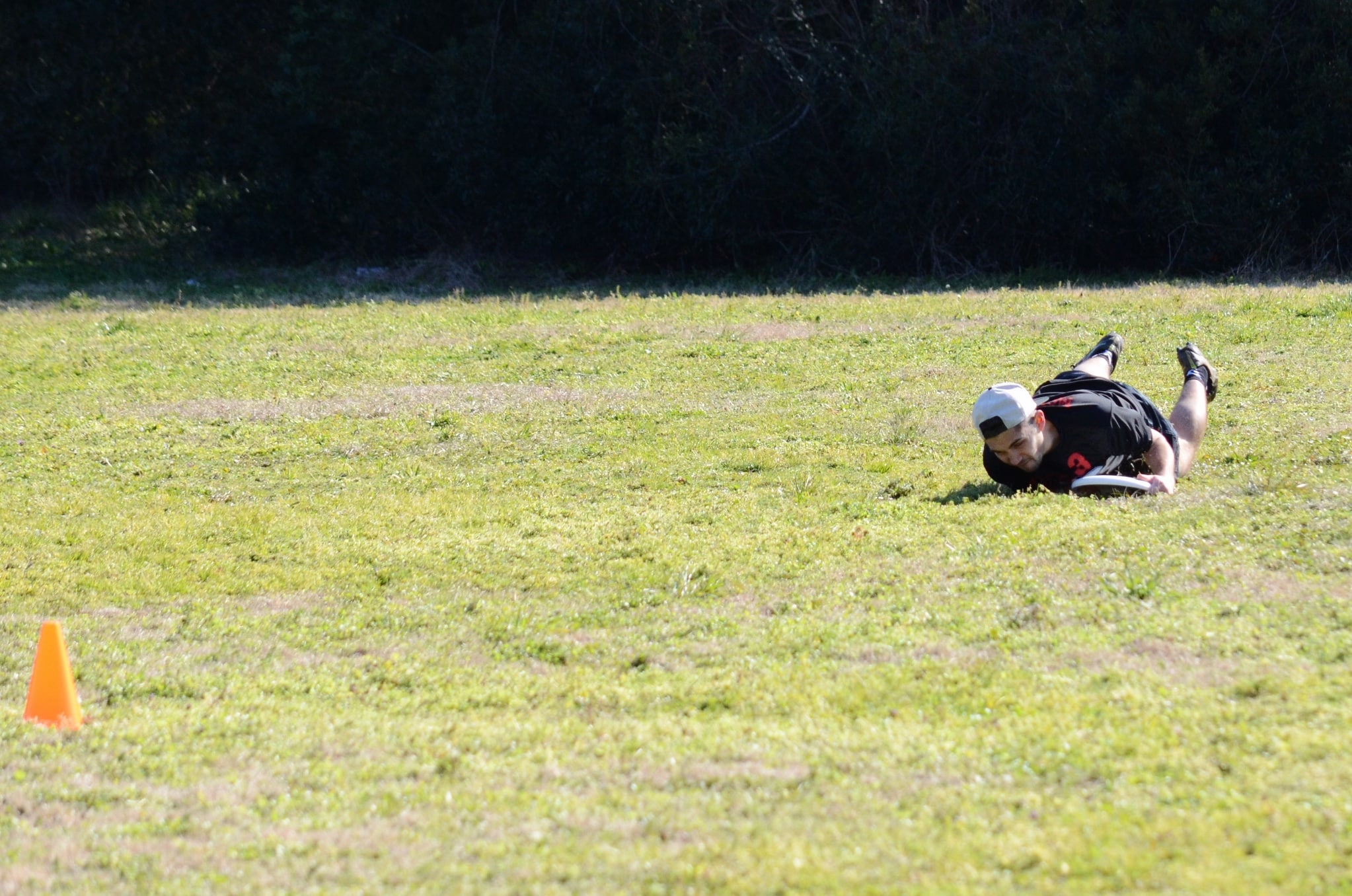 Josh Mckeown lies out for the disc to receive a point for his team.&nbsp;