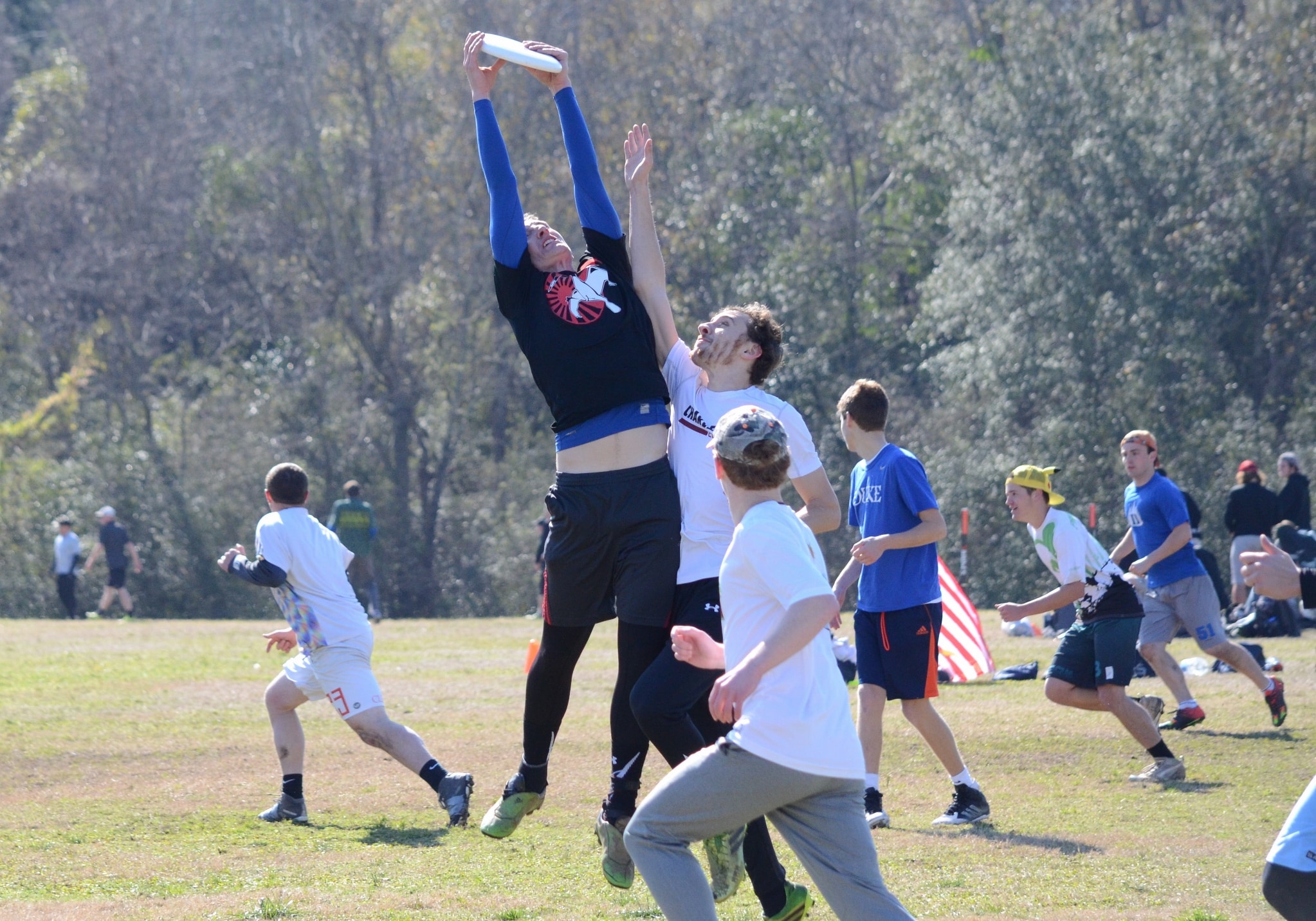 Jacob Campbell jumps over his opponents to catch the disc.&nbsp;