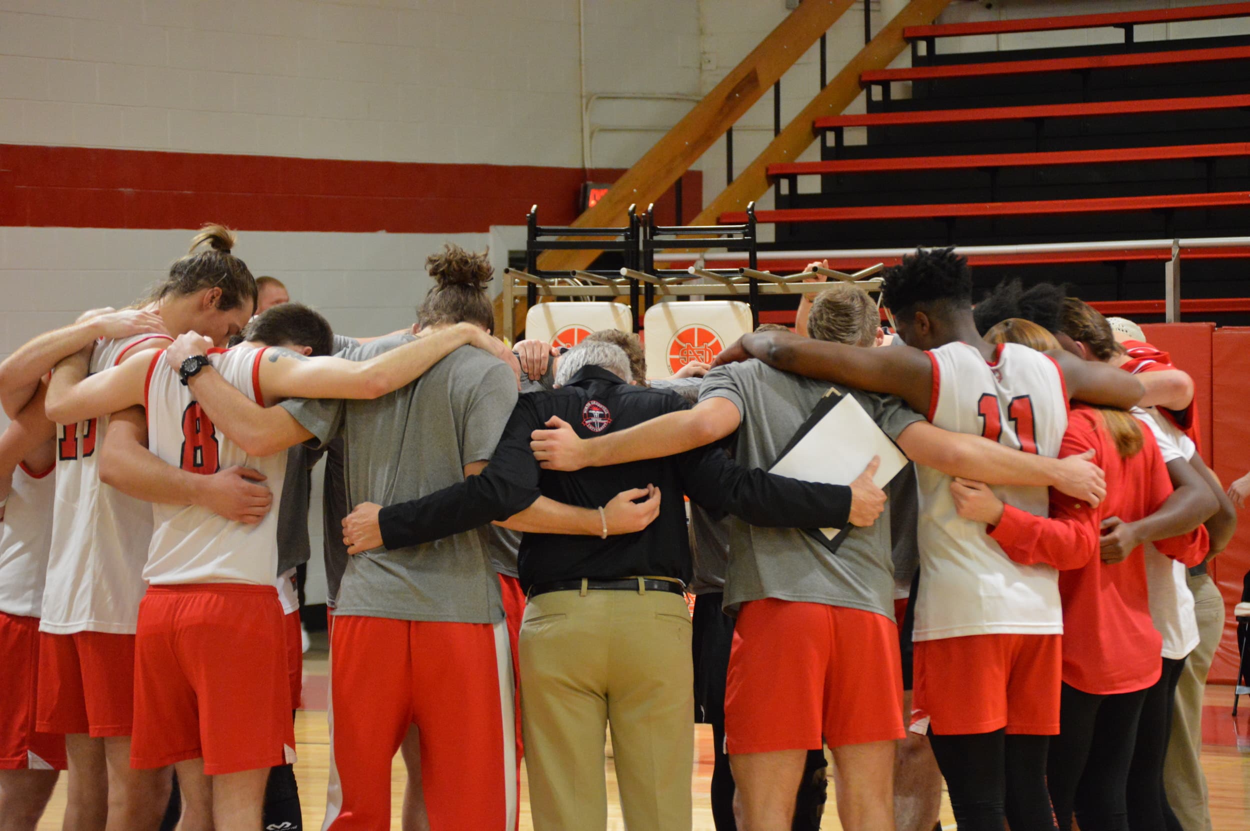 The team, along with the coaches, say a prayer after the game is over.