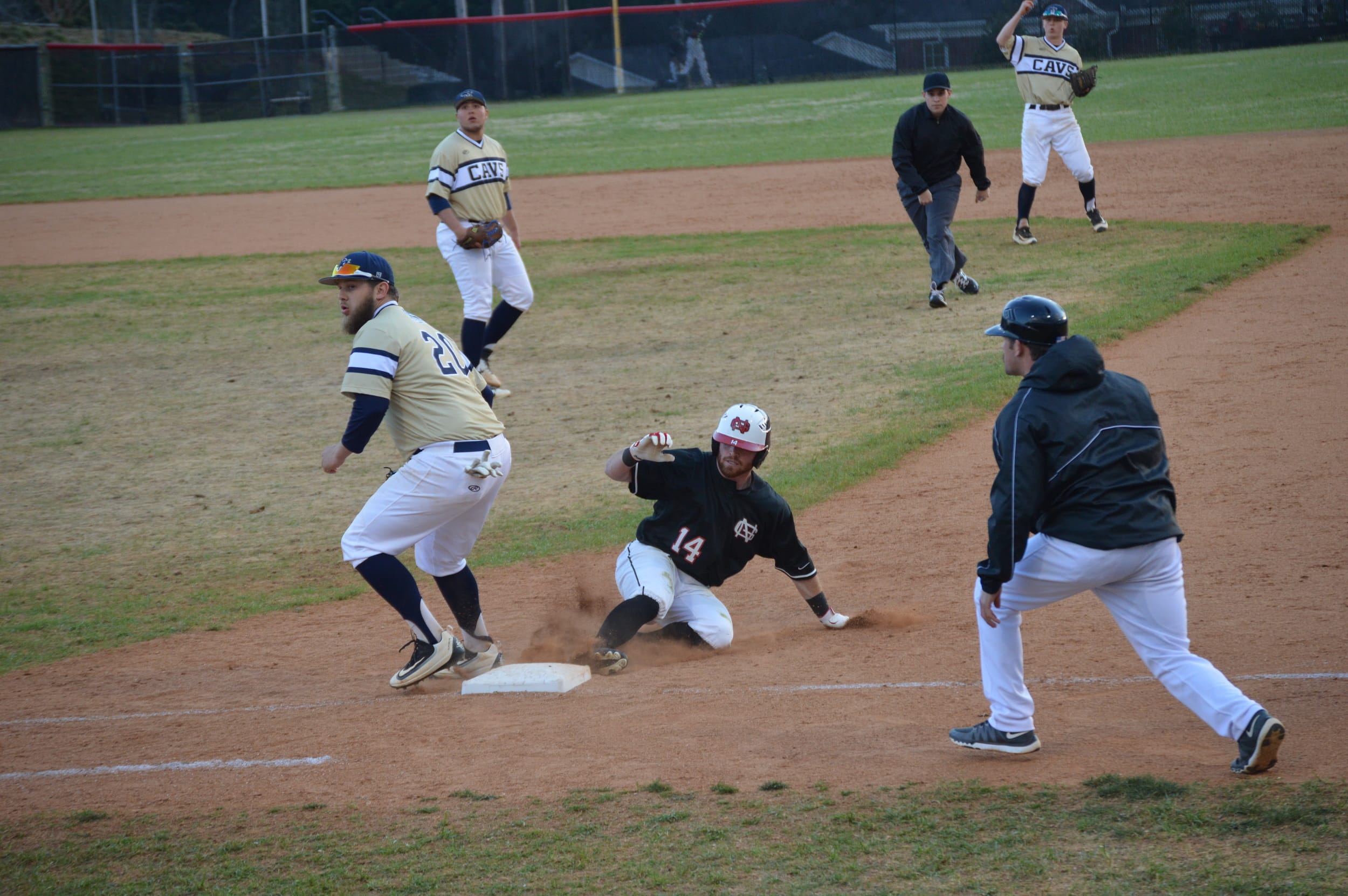 Mitchell Painter slides back to first base.