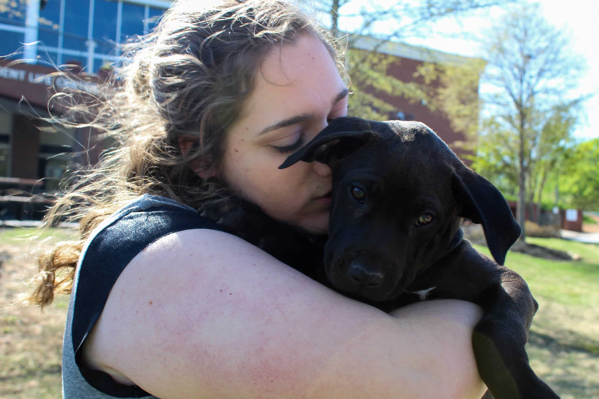 Nicole Pollard, an early childhood education major, holds one of the girl puppies.