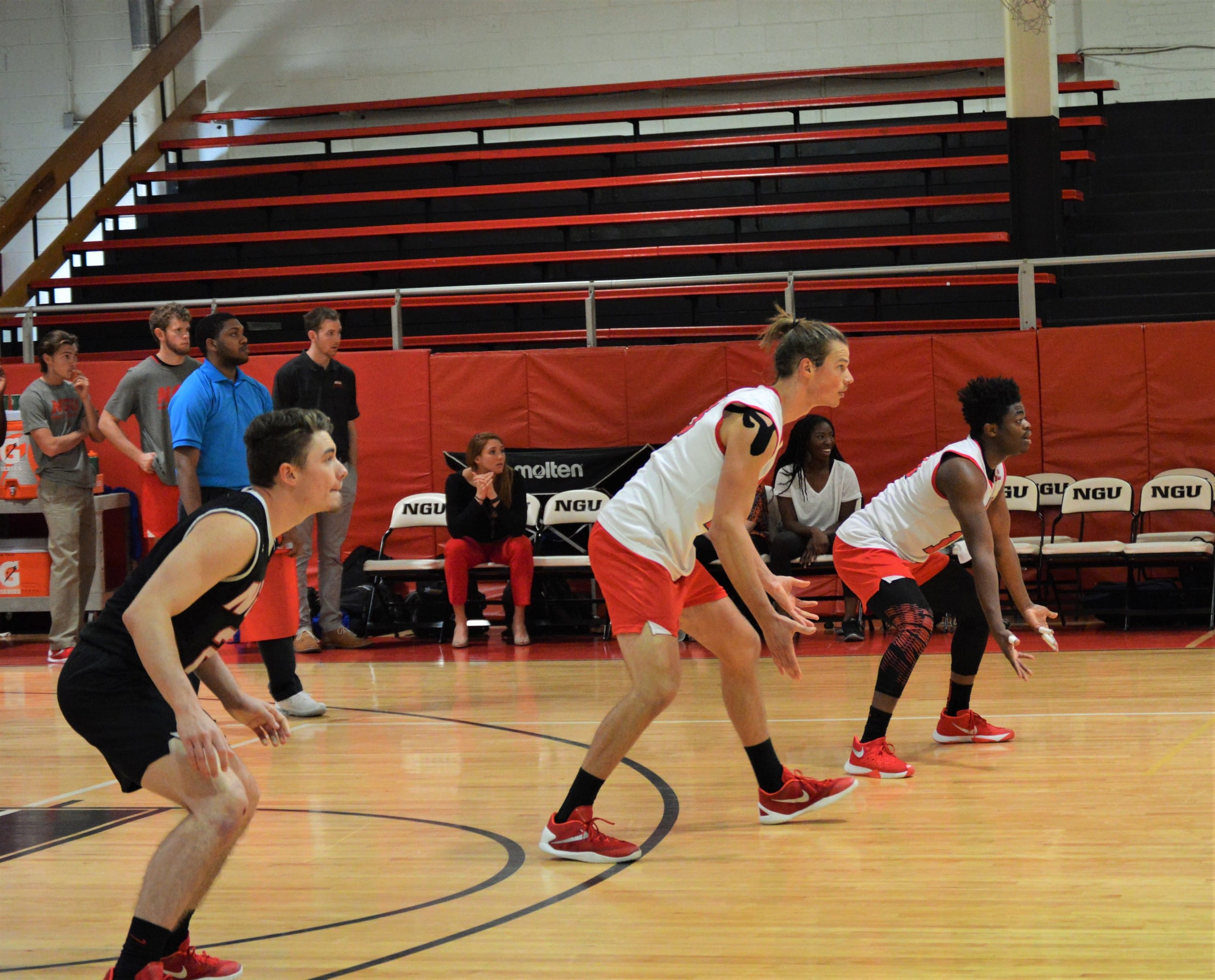 Dustin King, Jon Childes and Caleb Arelus wait for the other team to serve the ball.