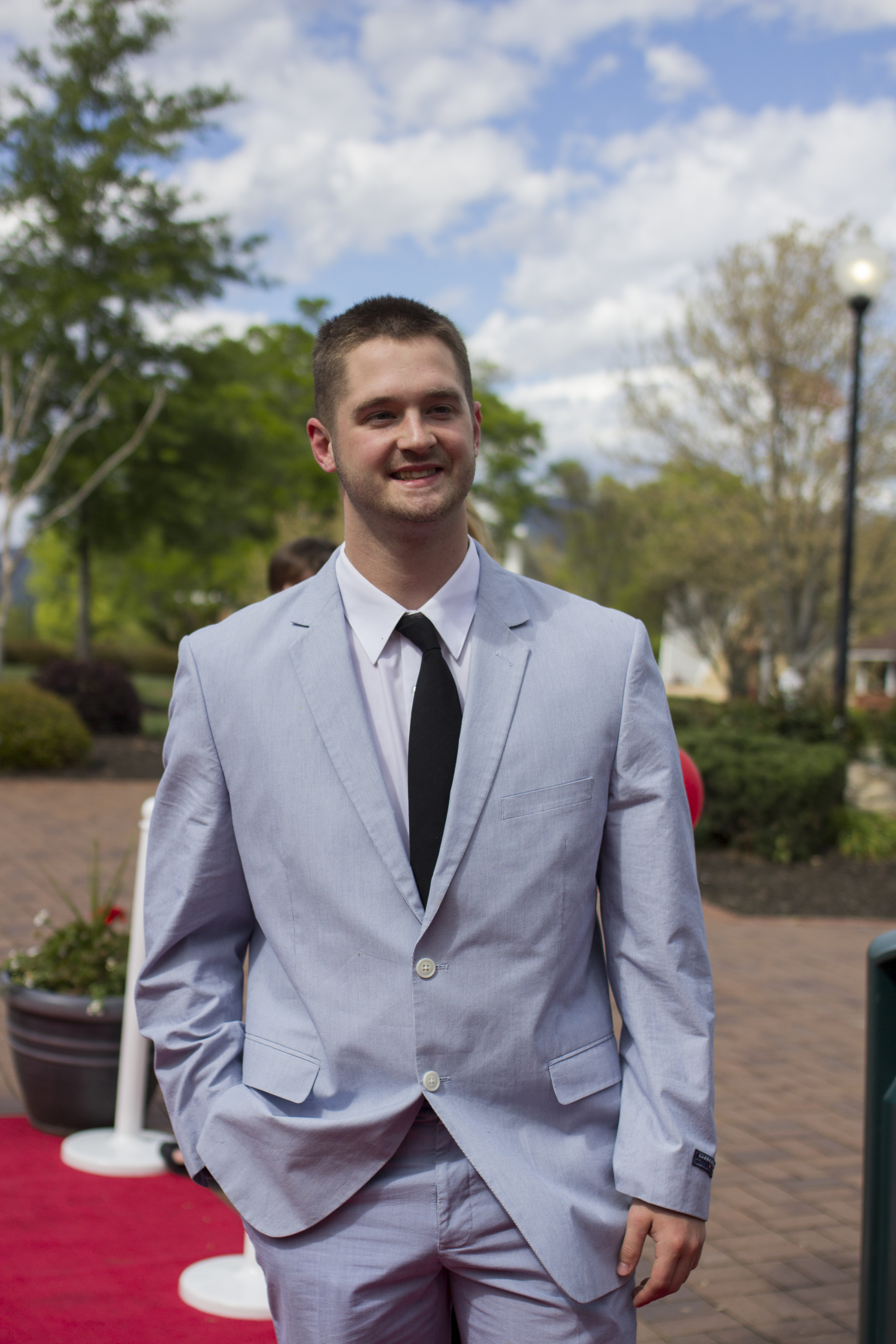 Matthew Ennis casually walks down the red carpet as if he was born for it.