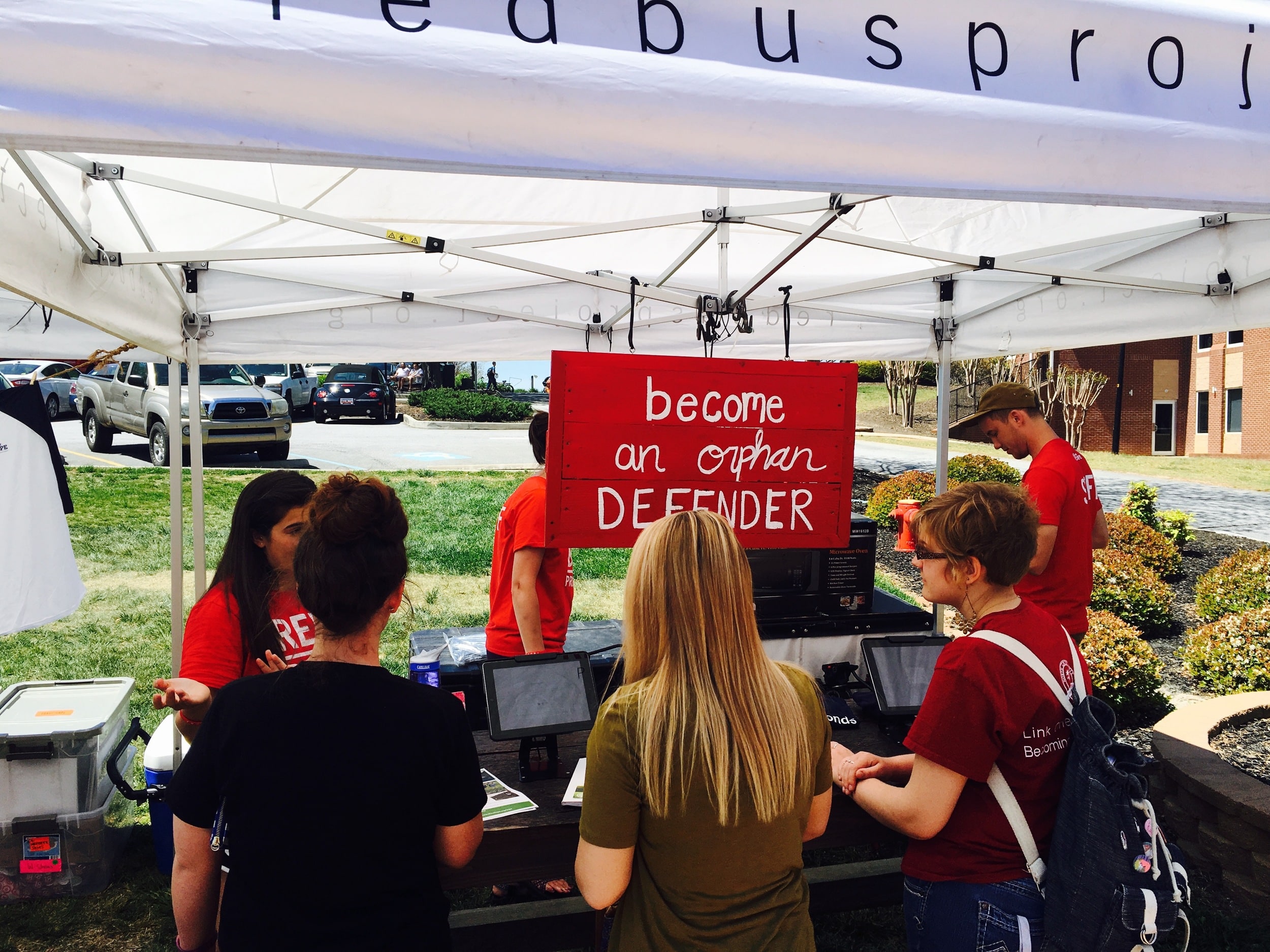 Students signing up to receive e-mail updates from the Red Bus Project. Photo courtesy of Christian Segers&nbsp;