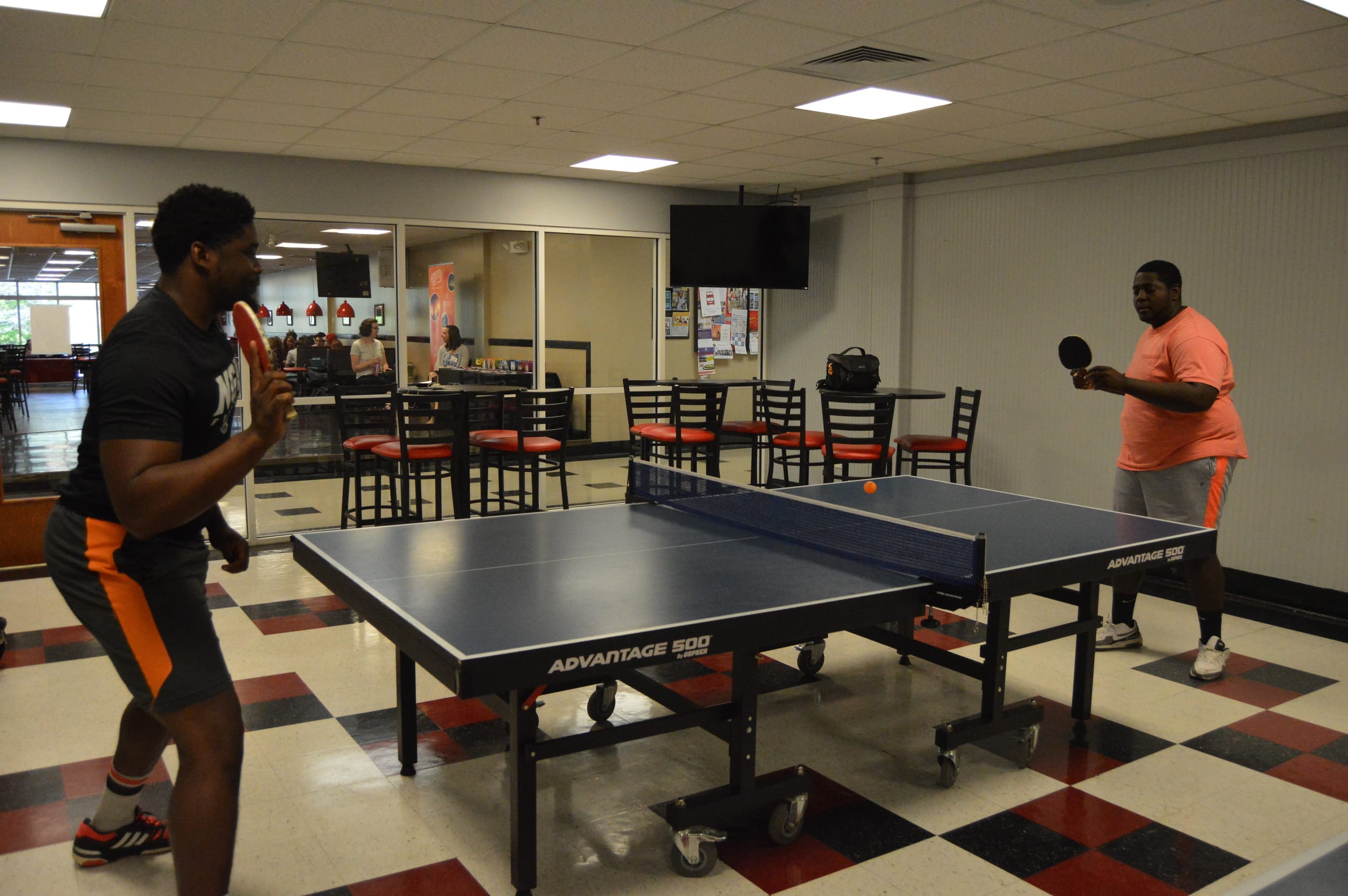 Dominique Richardson and Shamark Anderson face off in an intense match of ping pong.