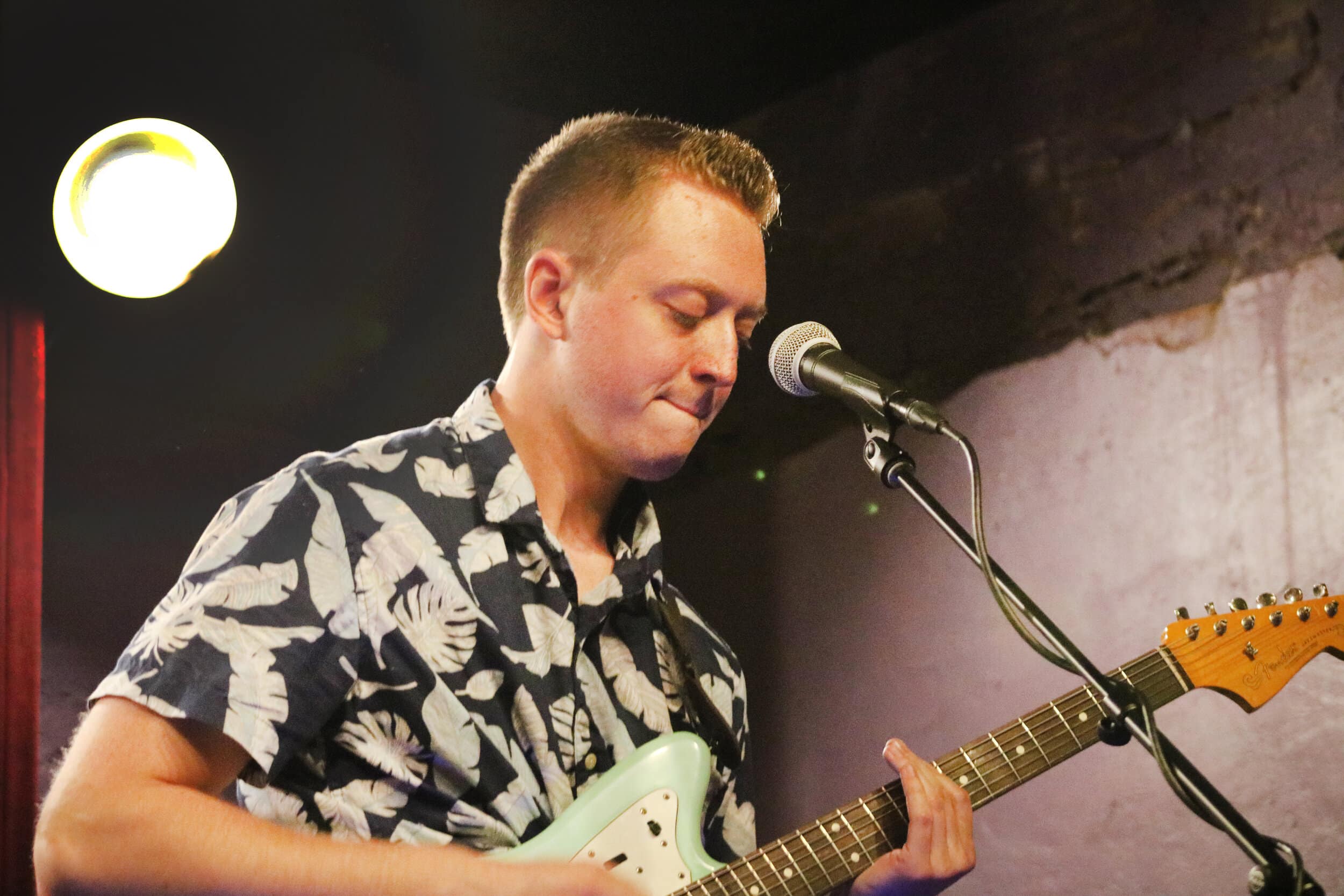 Vander Mei focuses on his guitar while playing their songs throughout the night.