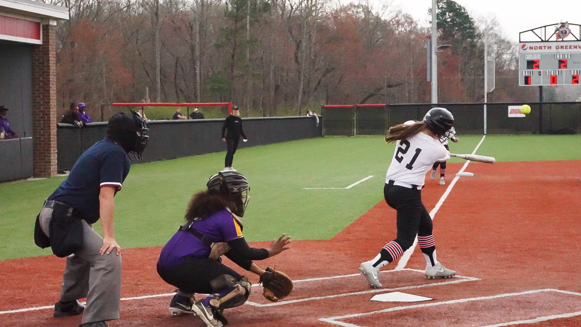 Sarah Holstrom, freshman, swings and hits the ball.