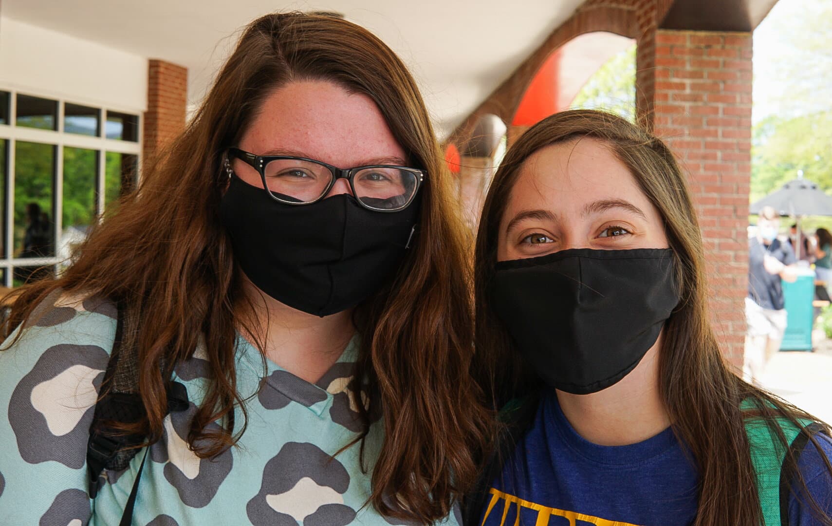 Freshmen Spanish education majors Emma Carver and Stelly Musser smile for a quick picture before getting their treats.
