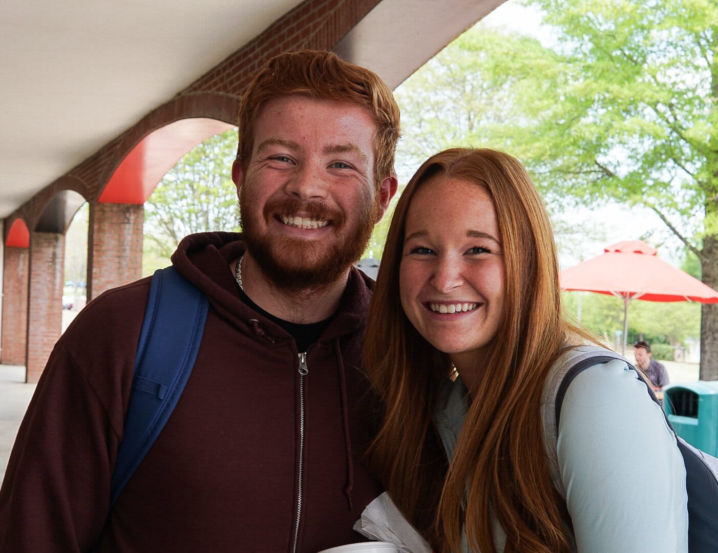 Sophomore Christian studies major Connor Hampton and freshman health science major Mackenzie Sturgill take a break to get some treats from the table and catch up on the days occurrences.