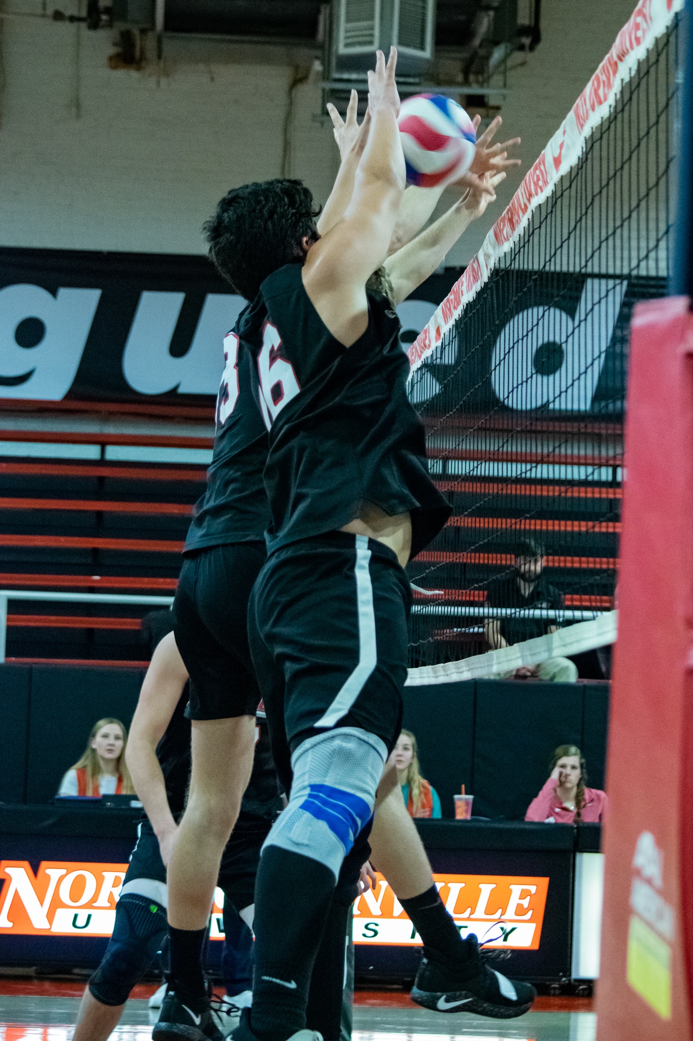 Hamsho (13) and Carrillo (16) jump up simultaneously in order to block the ball.