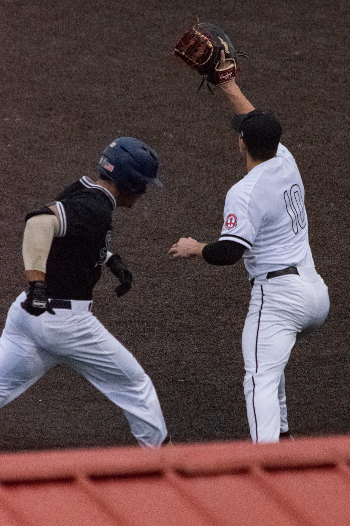 Sasser (10) gains the Crusaders second out as he catches the ball on first base.