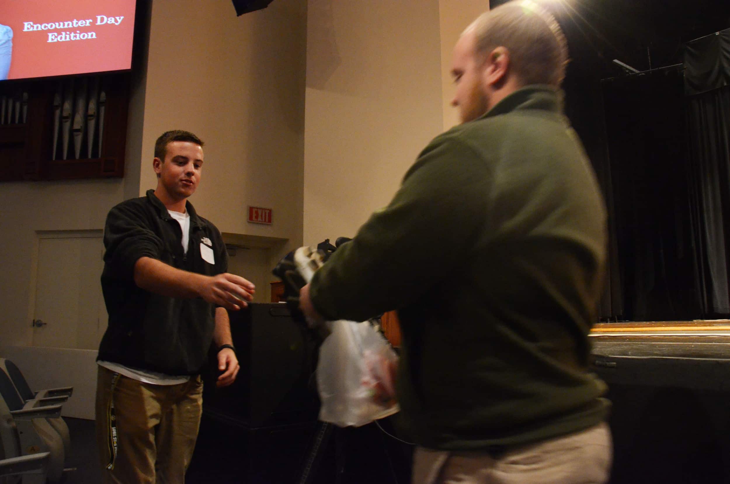  A potential student receives a prize delivered by Travis Brian, a Campus Ambassador.&nbsp; 