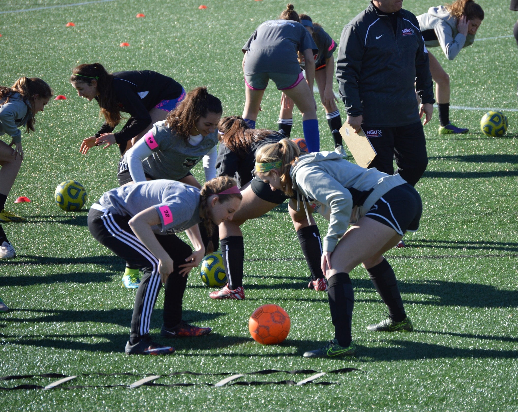 The students engaged in a soccer ball warmup to get things started.