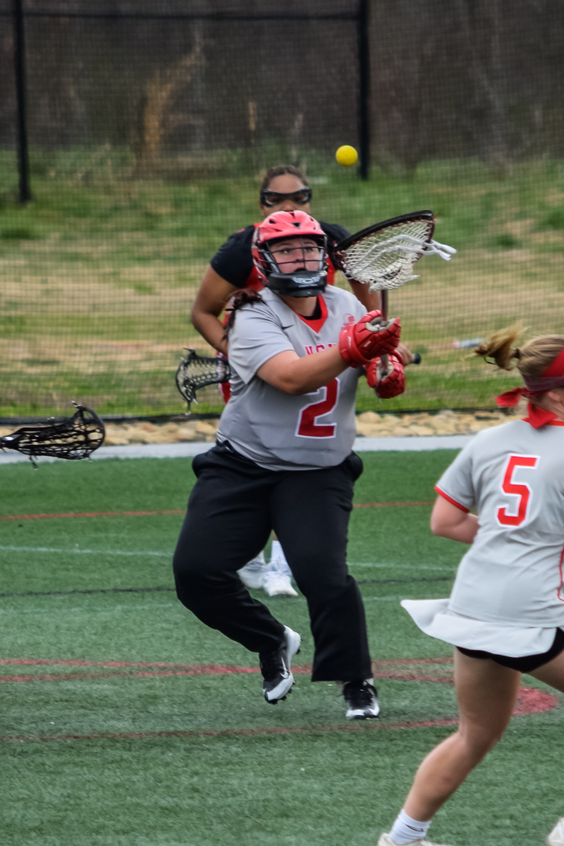 Goalie #2 Sydney Taylor rushes to catch the ball to get it back in NGU's hands.