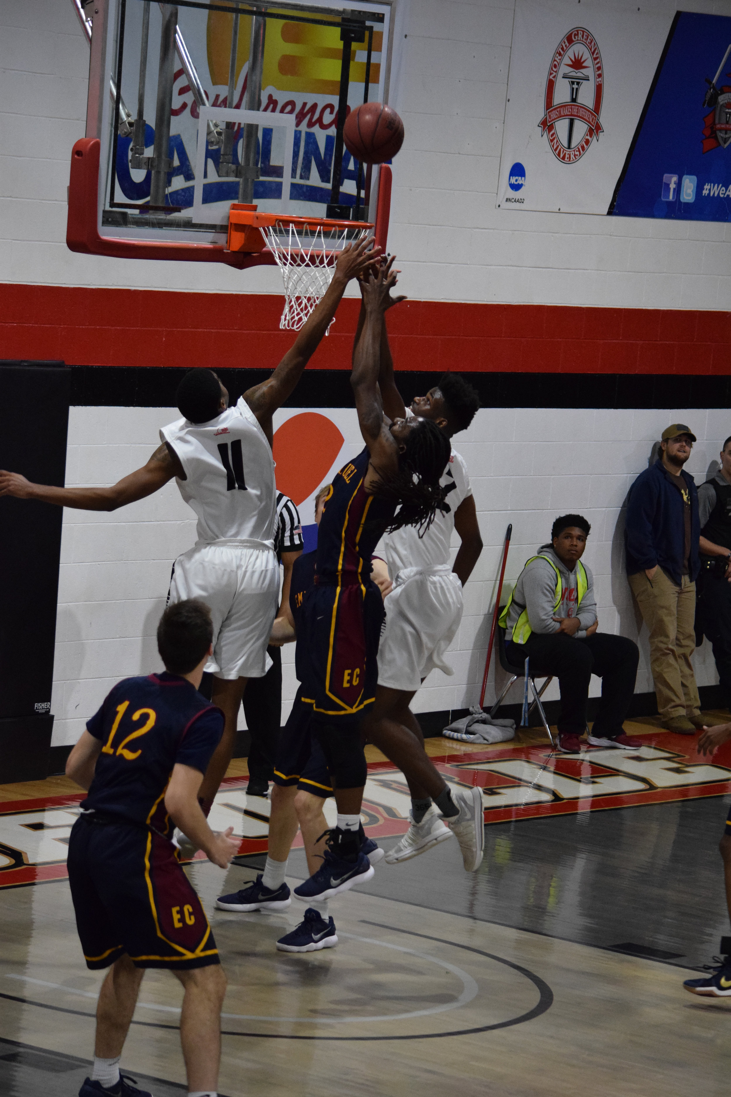 NGU's #11 Jalon Cokley and #2 Moses Merritt go to block Emmanuel College's #2 Kurtis Robinson.