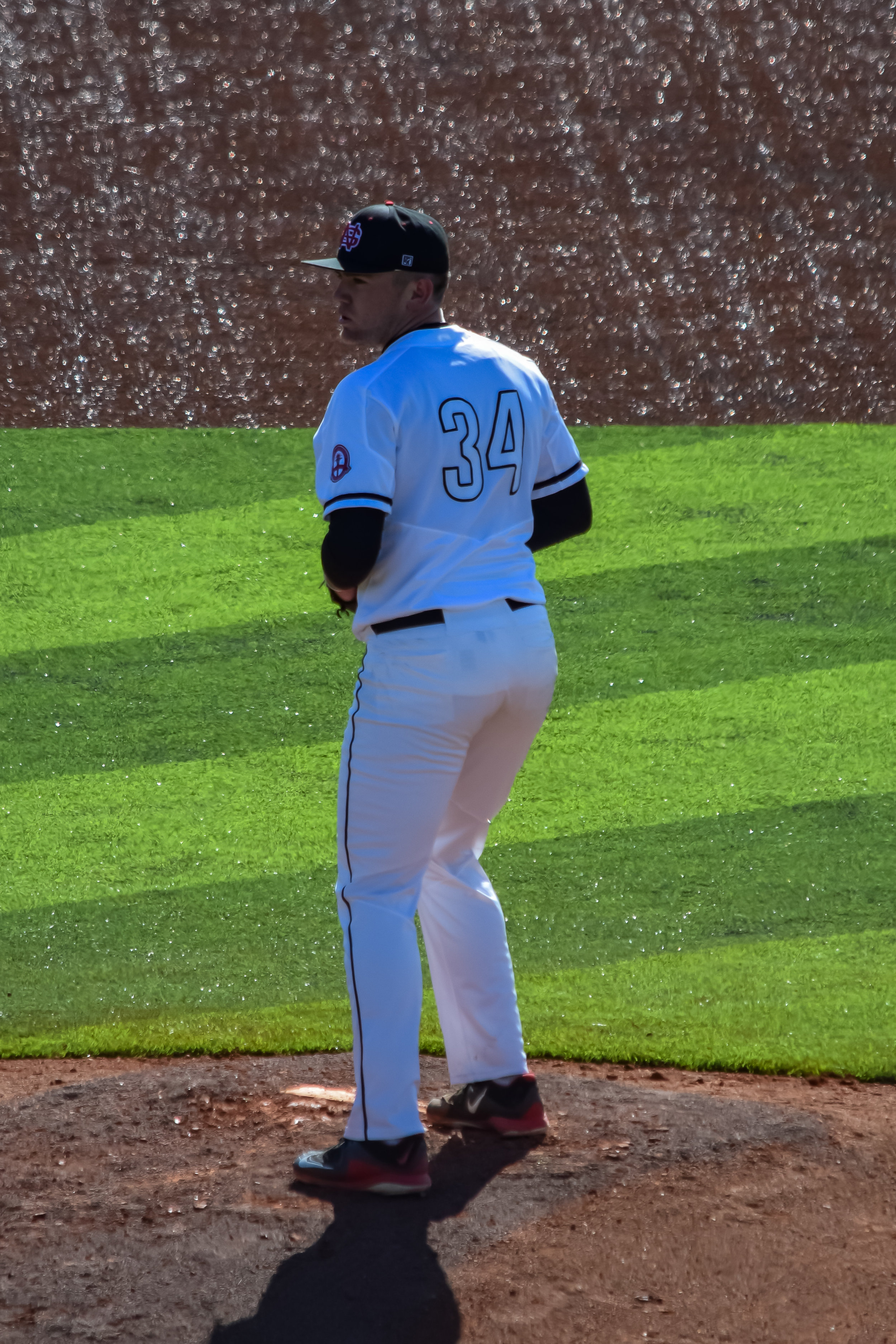 Pitcher #34 Jared Lembcke gets ready to send the ball right down the middle to try to get the batter out.