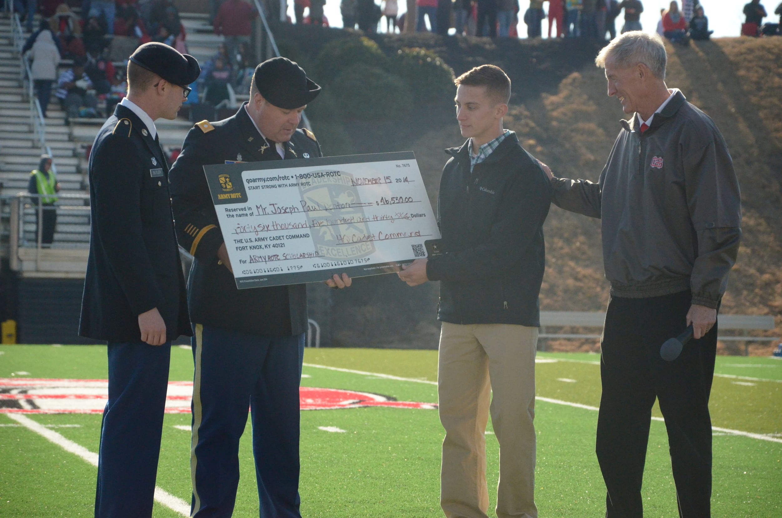  The U.S. Army is giving Joseph Denton a check to support his pursuit in the ROTC. 