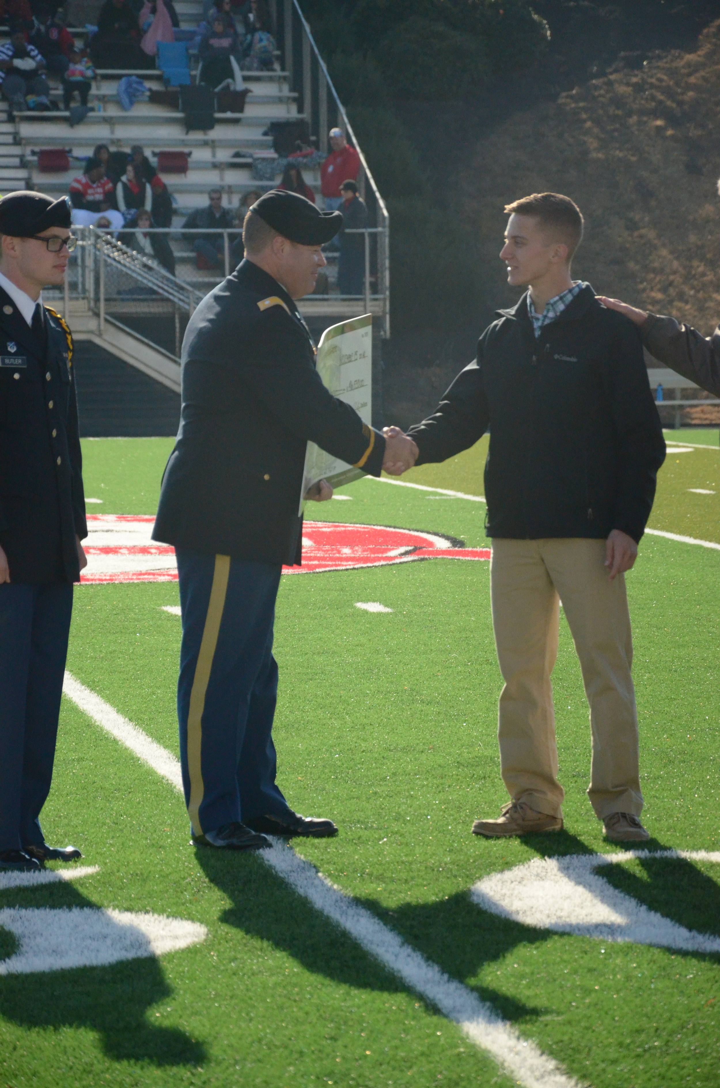  Mr. Scrivens and Denton share a congratulatory hand shake. 