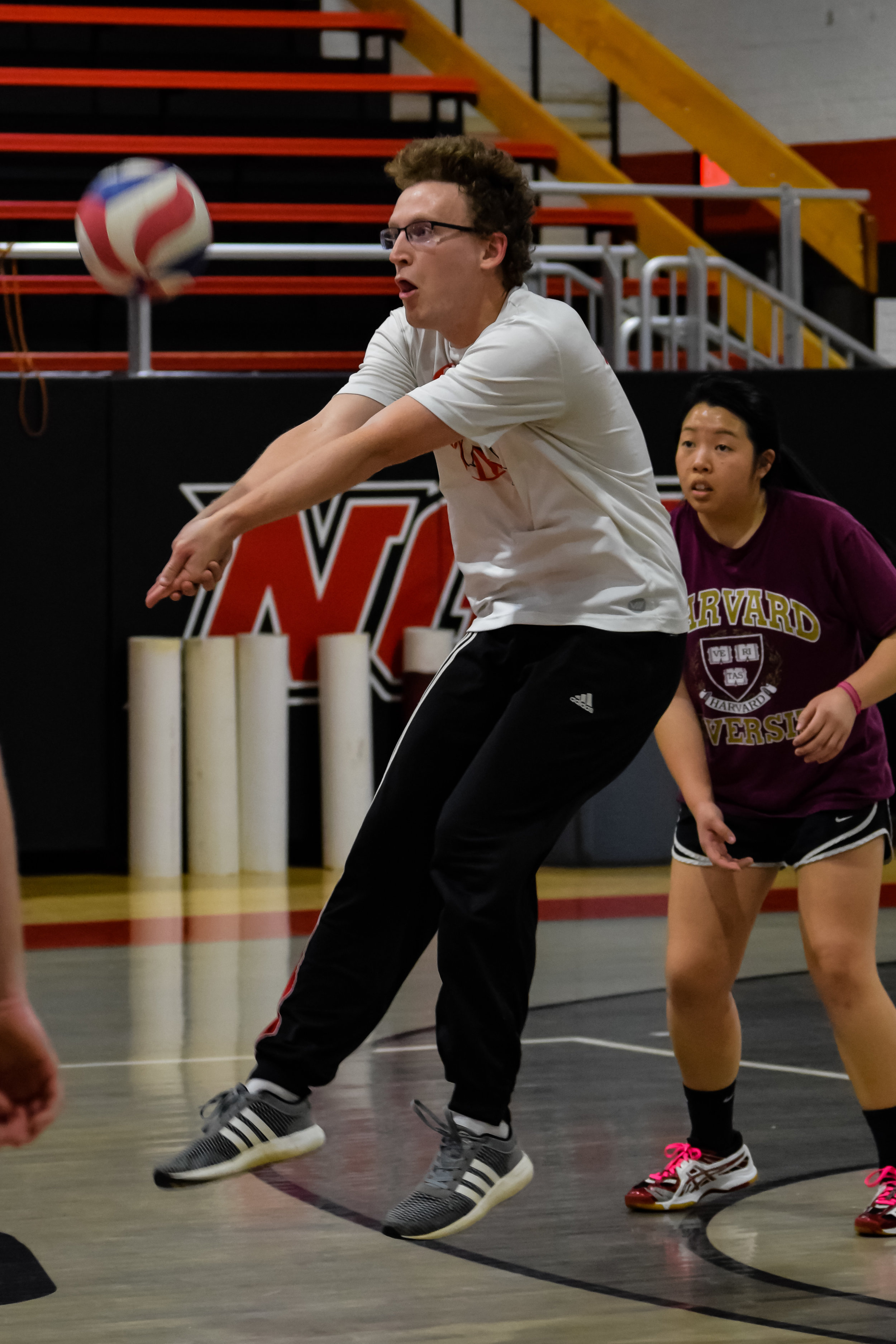 Ford Pfister shows off his war face as he braces to hit the ball while Dori Kelly rushes in for support.