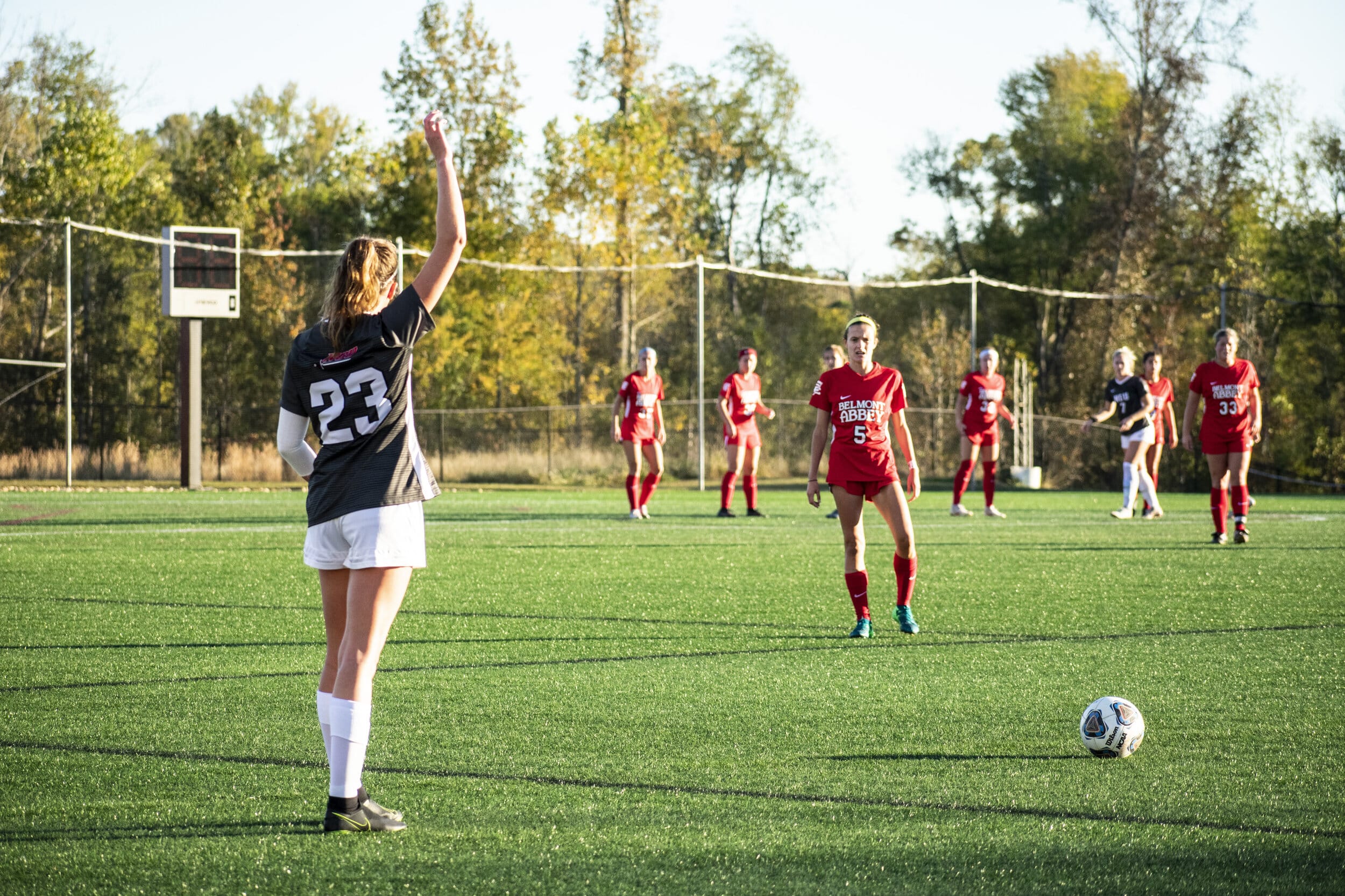 Sophomore Sarah Hazelwood (23) kicks the ball into play.