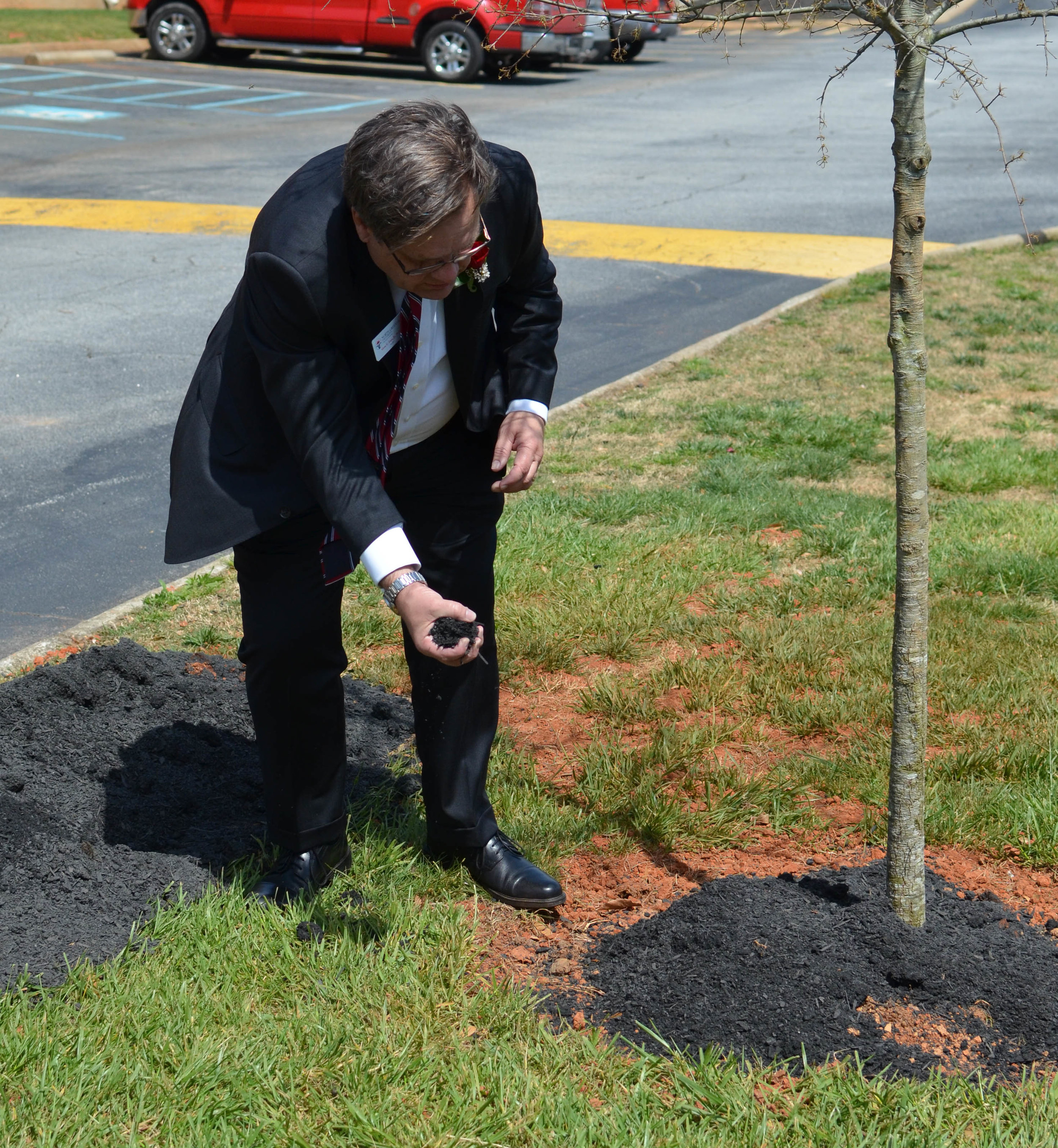 North Greenville President Dr. Gene Fant pouring dirt in traditional fashion.