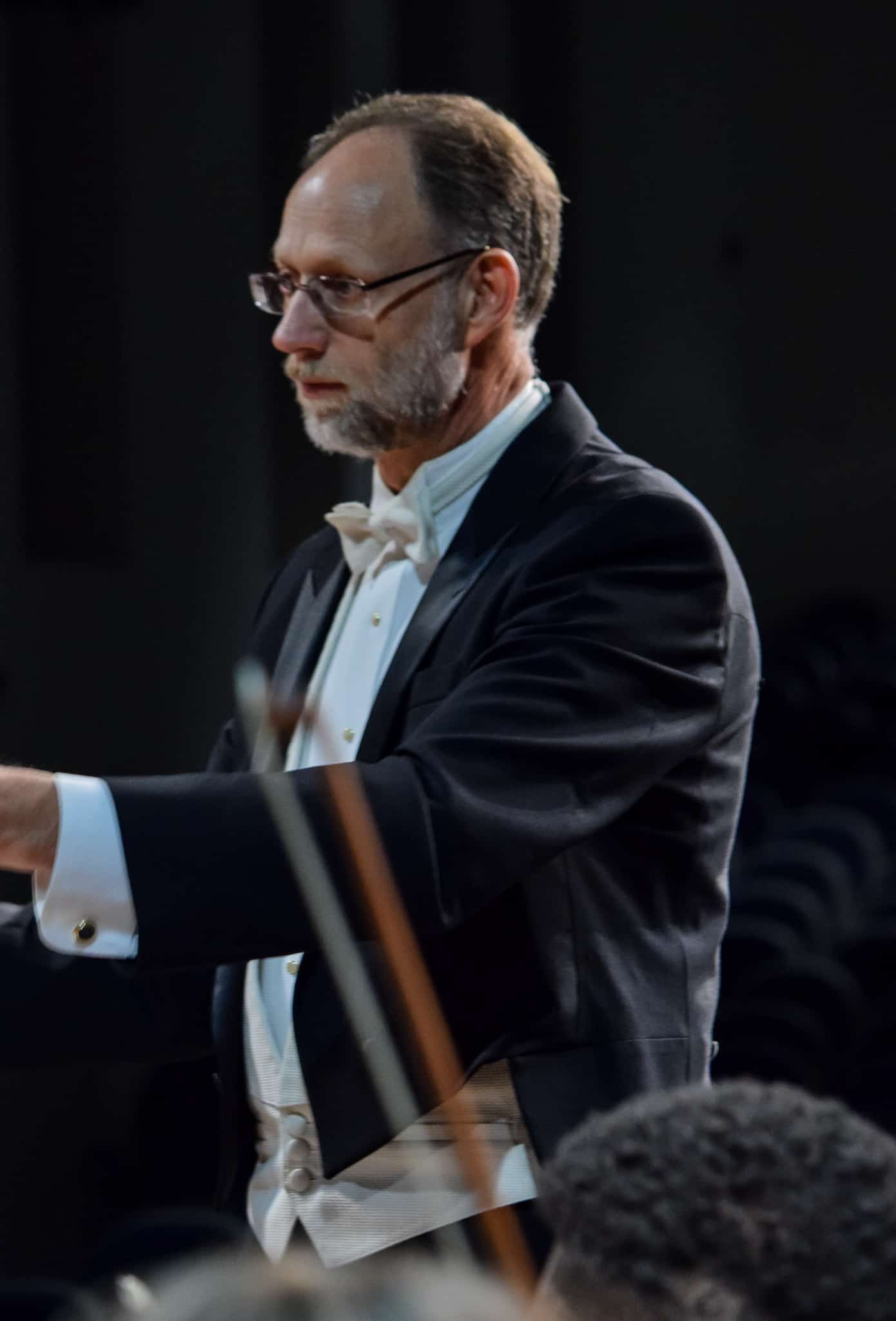 Conductor Michael Weaver shows his focus as he makes sure the orchestra stays in time.