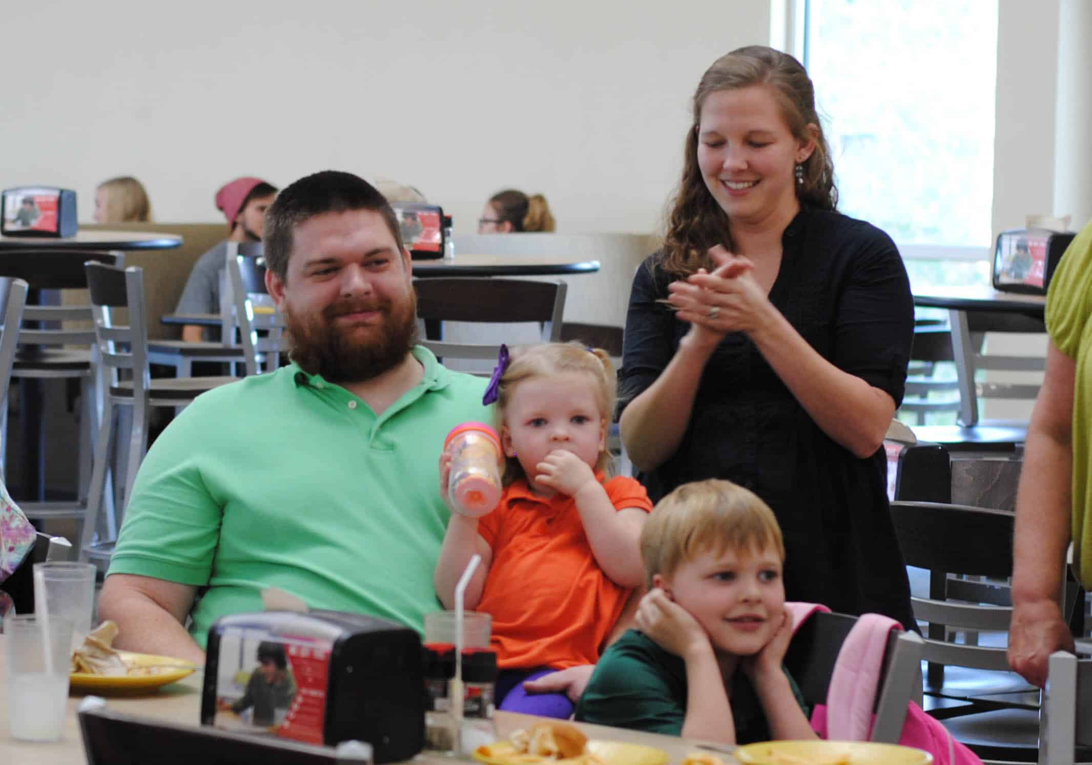 Mike, Miquila, Liam and Callie Sizemore happily watch a signed NGU cheer.&nbsp;