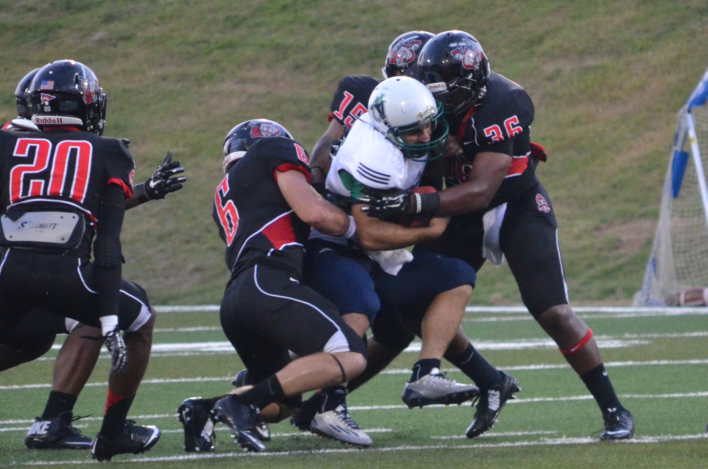  Taylor Anderson and Jalen Hammett work together to tackle an opposing team member 