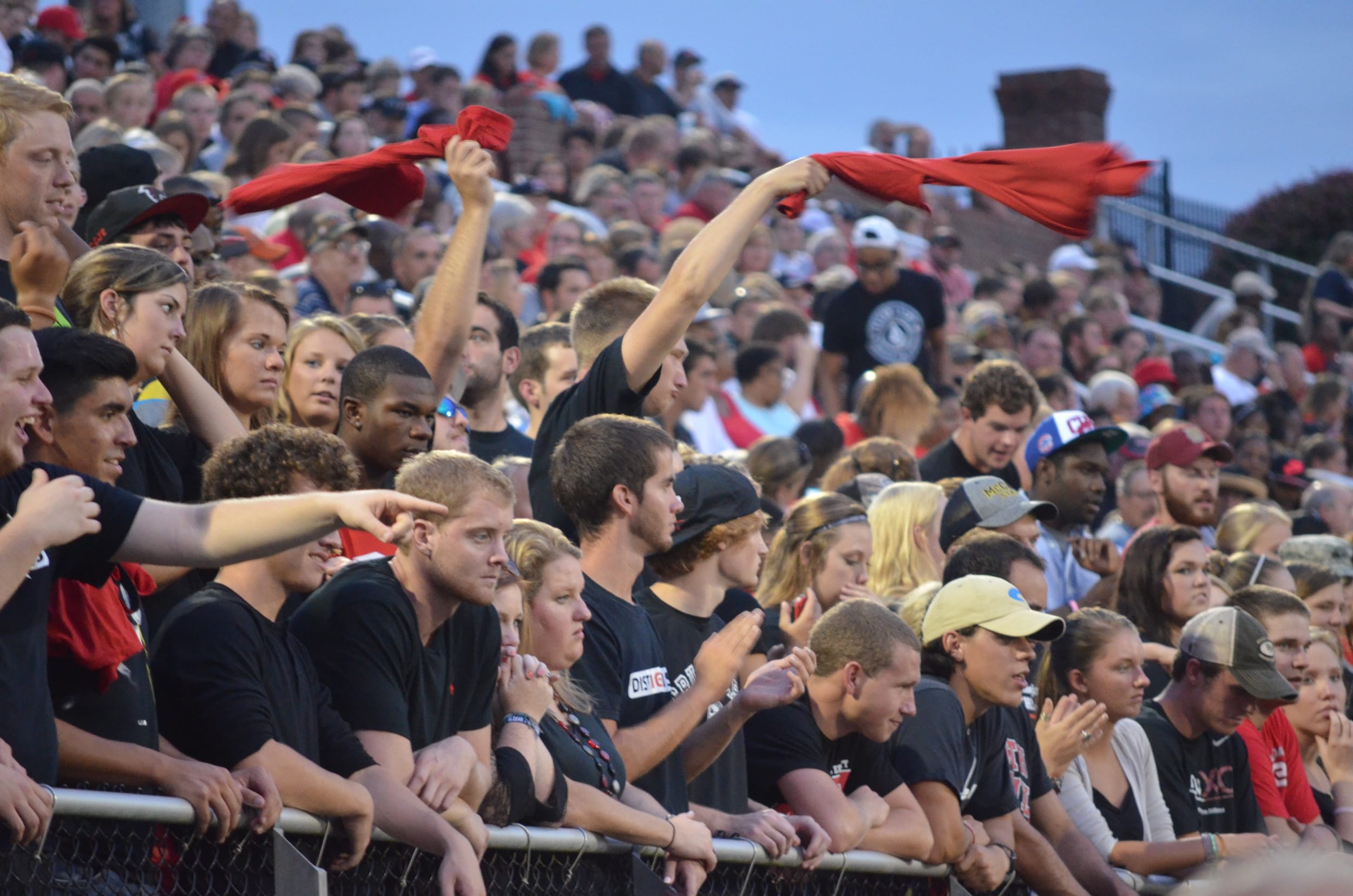  Fans cheer on the team by shouting and twirling rags 