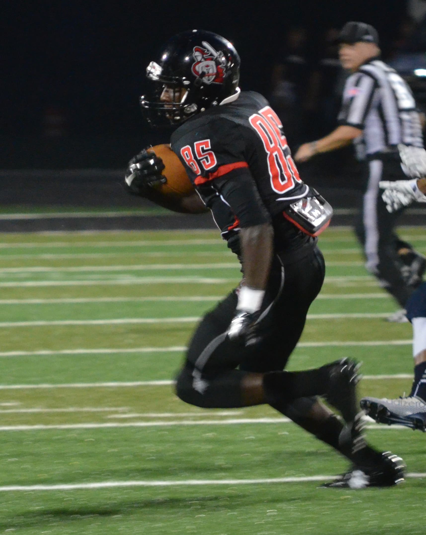  Wide Receiver, Robbie Brown, makes a run for the endzone while dodging the other team 