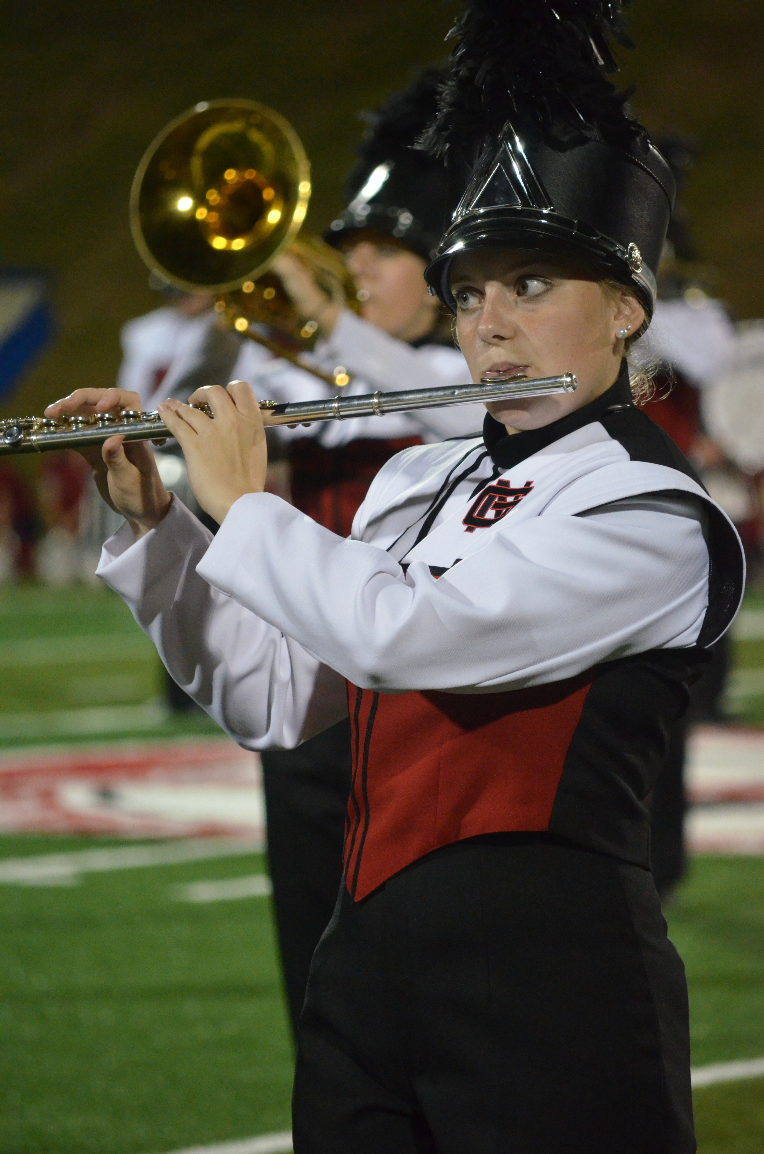 This clarinet player keeps her focus on the drum major so she doesn't miss a beat 