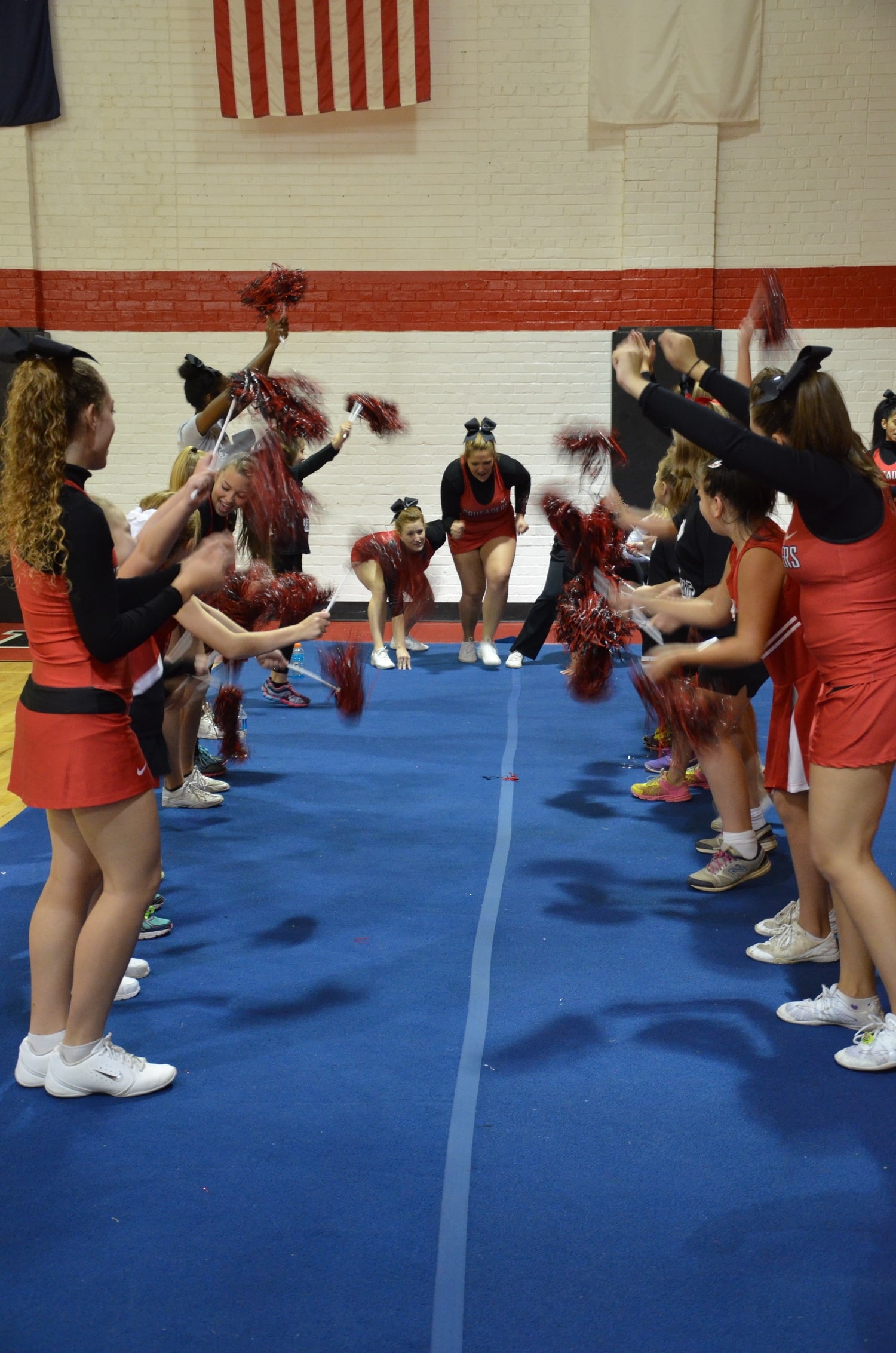  NGU Cheerleaders prepare to run through a tunnel of mini-Crusaders at the NGU cheer camp held on campus Saturday, October 4. 