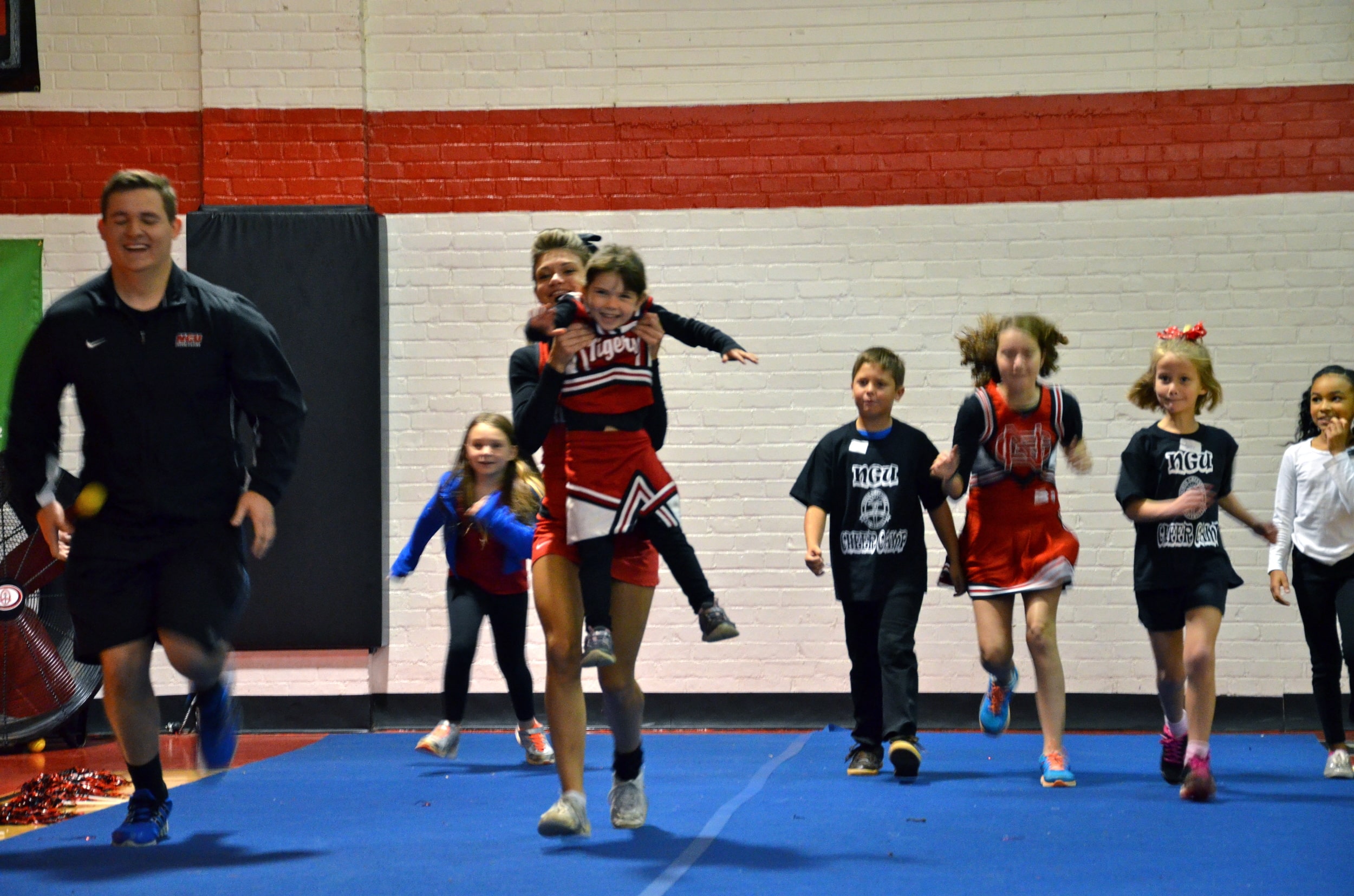  A mini-Crusader is getting a little help to the finish line at the cheer camp October 4. 