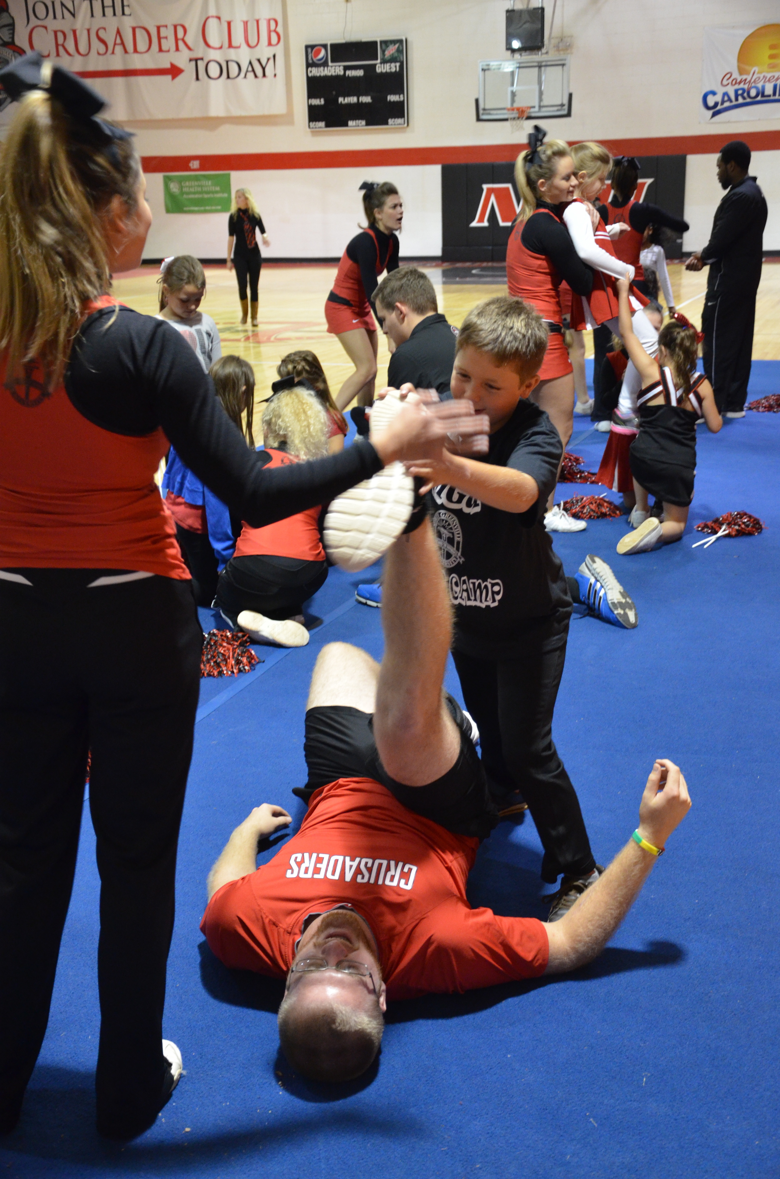  A big man needs a little help when it comes to stretching at NGU's cheer camp last weekend. 