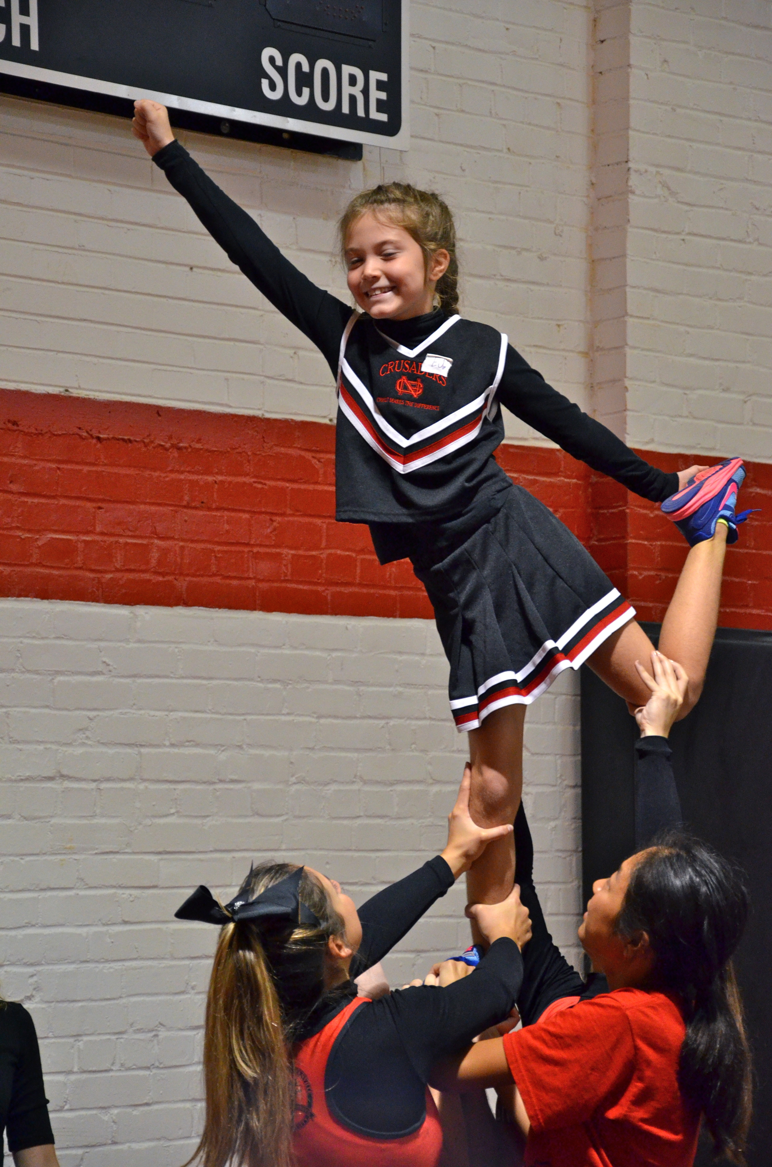  Smiles show all around for this cheery tyke as she holds her stance at NGU's cheer camp. 