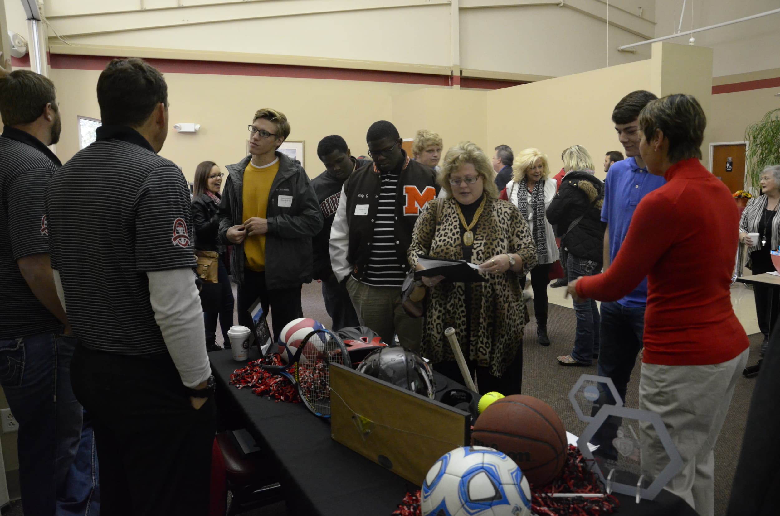  Coach McDonald, head of the Athletic Department, and other coaches talk to potential students about our athletic programs and scholarships. 