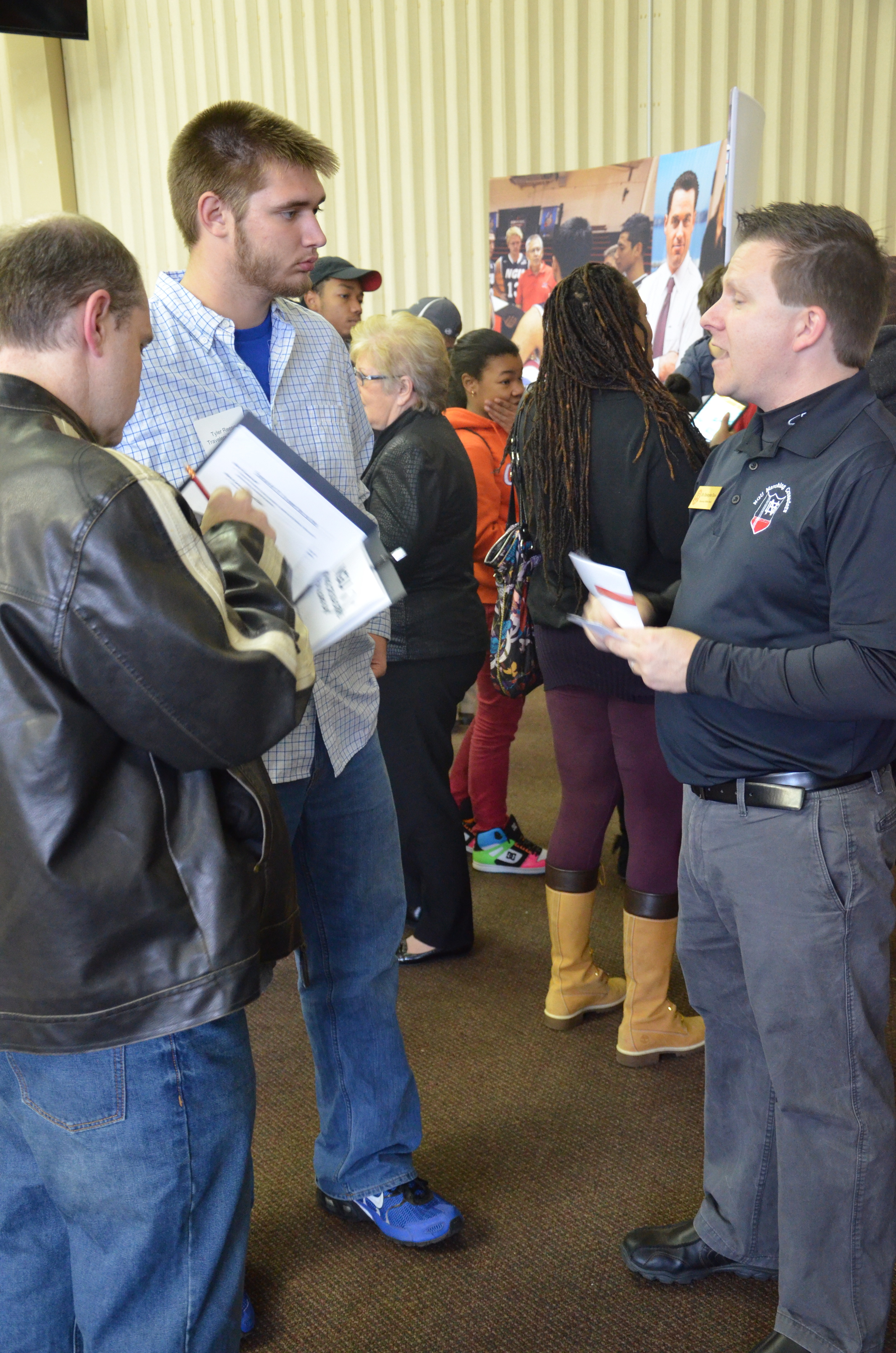  Christopher Davis, a fine arts teacher, talks to a potential student about the Fine Arts Department. 