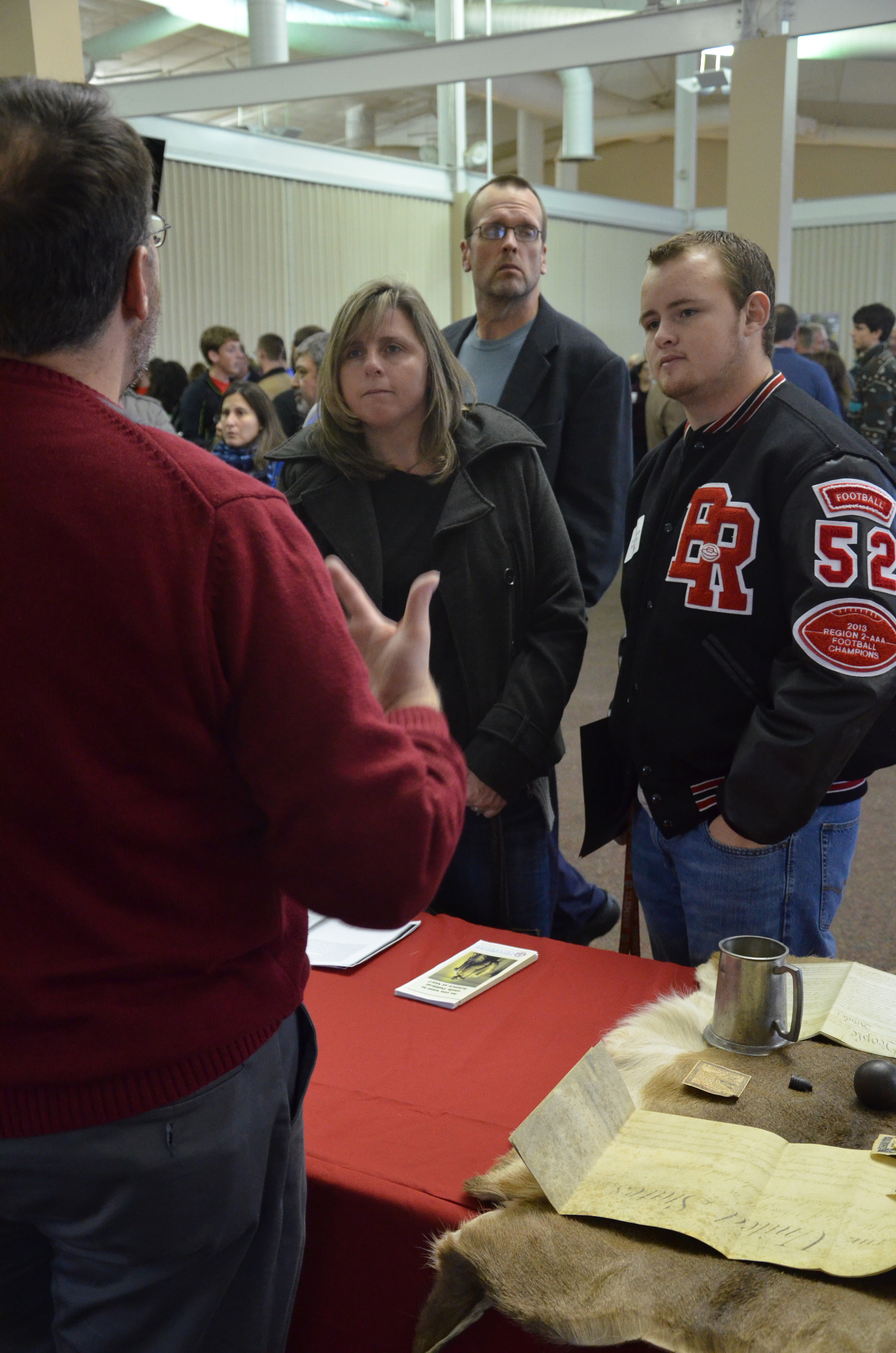  A visitor and his mom are listening to Dr. Roeder as he speaks about the Political Sciences of the school. 