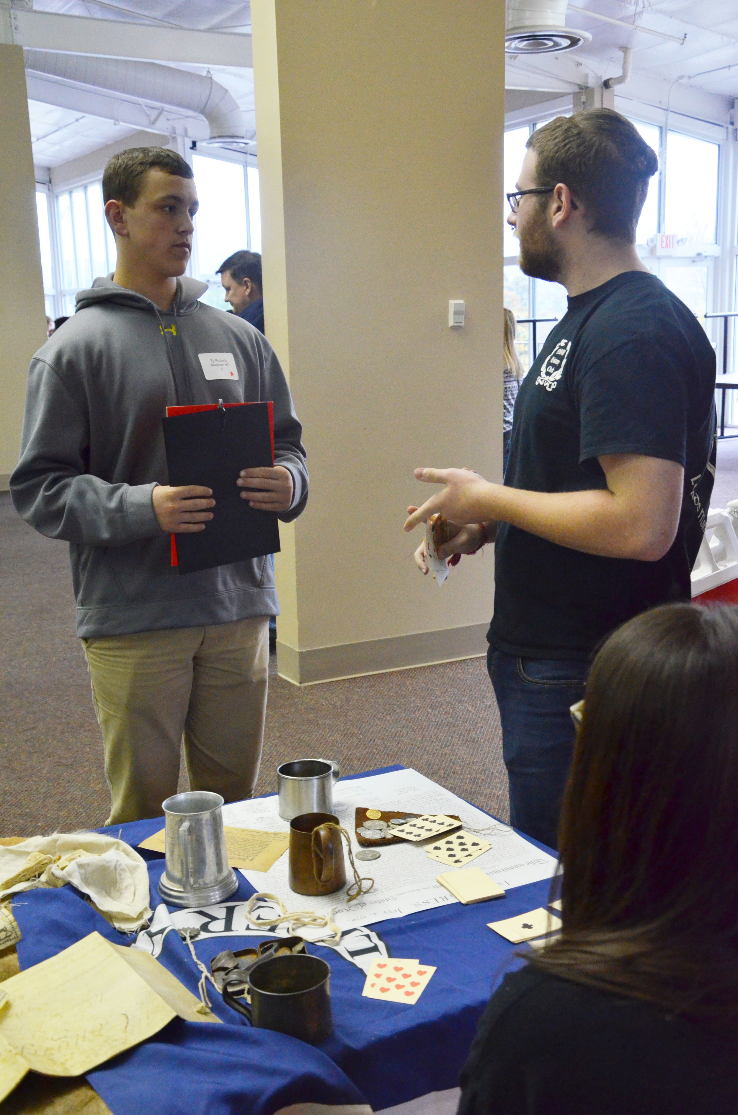  A North Greenville student is talking to a guest about the History Department on campus. 