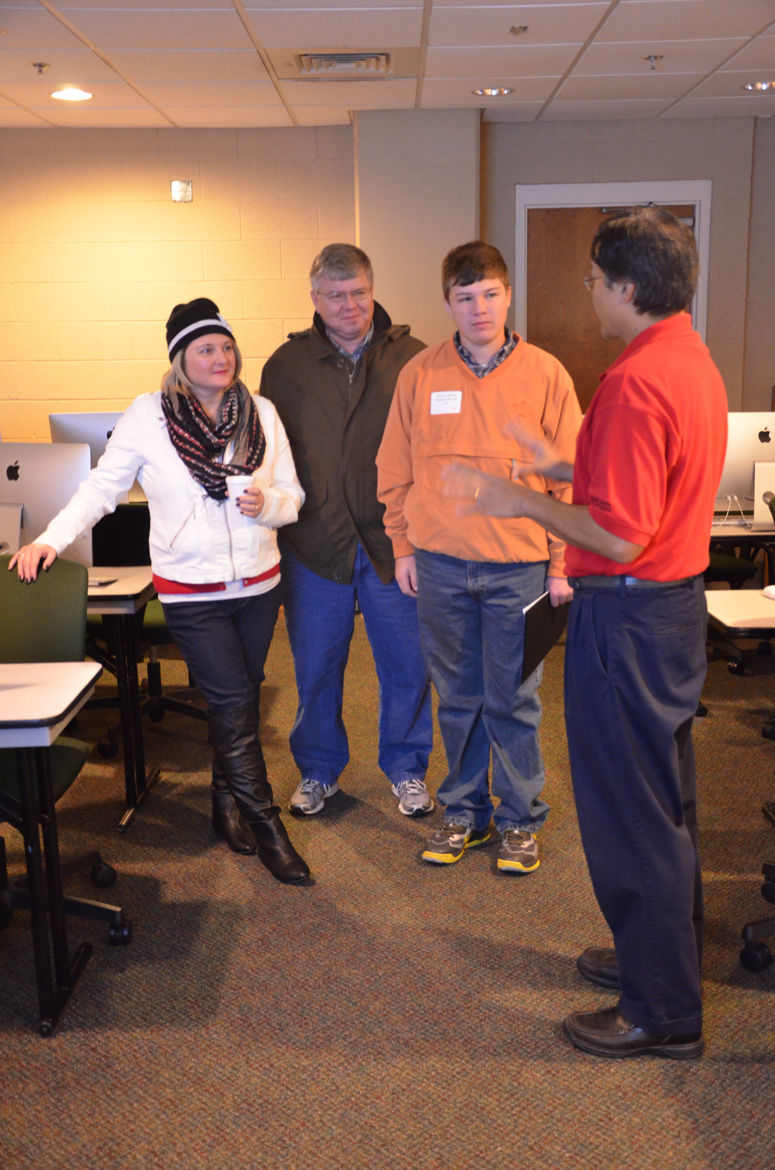  A family is taking a tour of the Mass Communications department. 