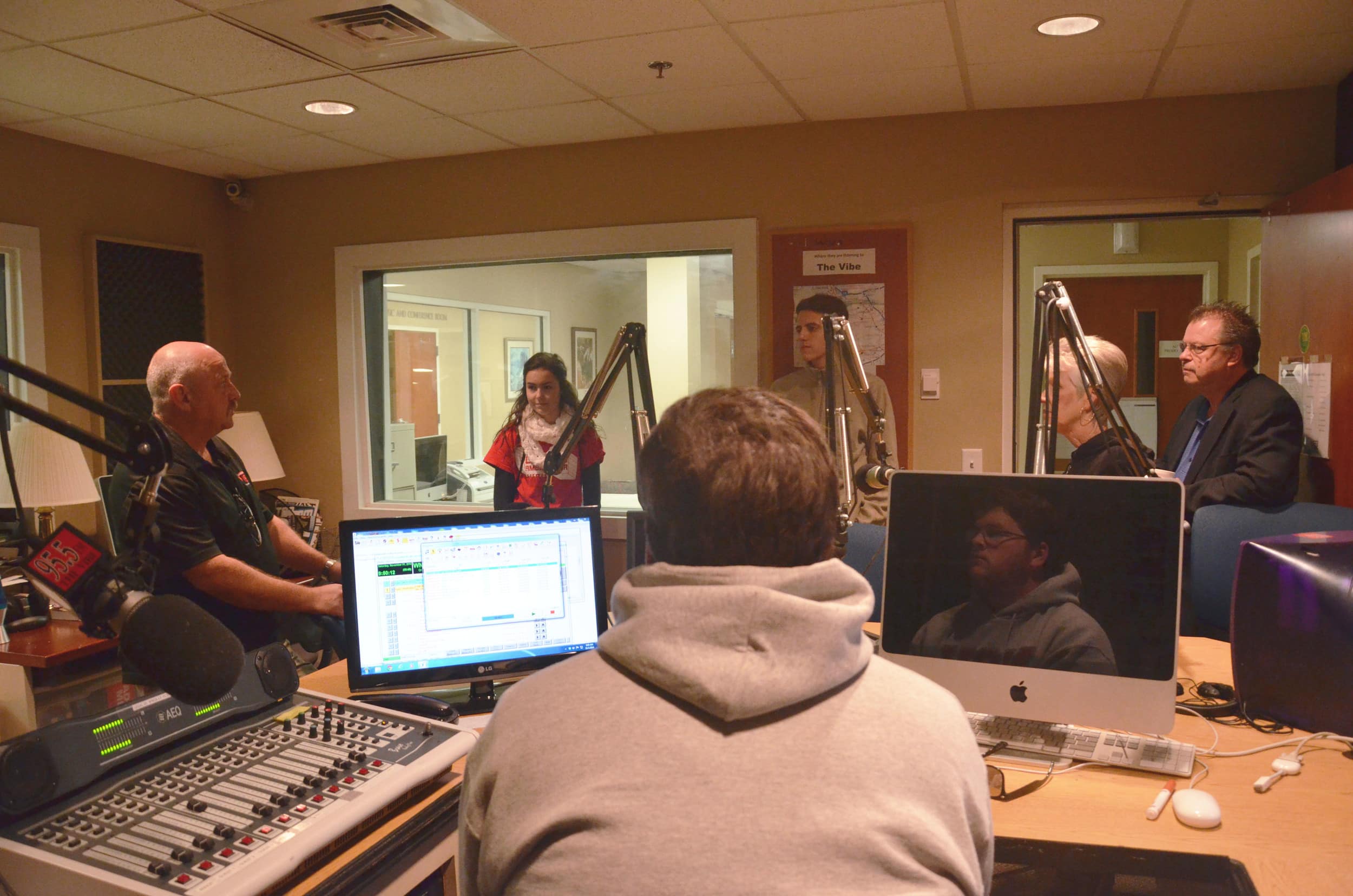  Mr. Stevens, a Mass Comm. Instructor, is informing these guests about the radio program in the Mass Comm. Department. 