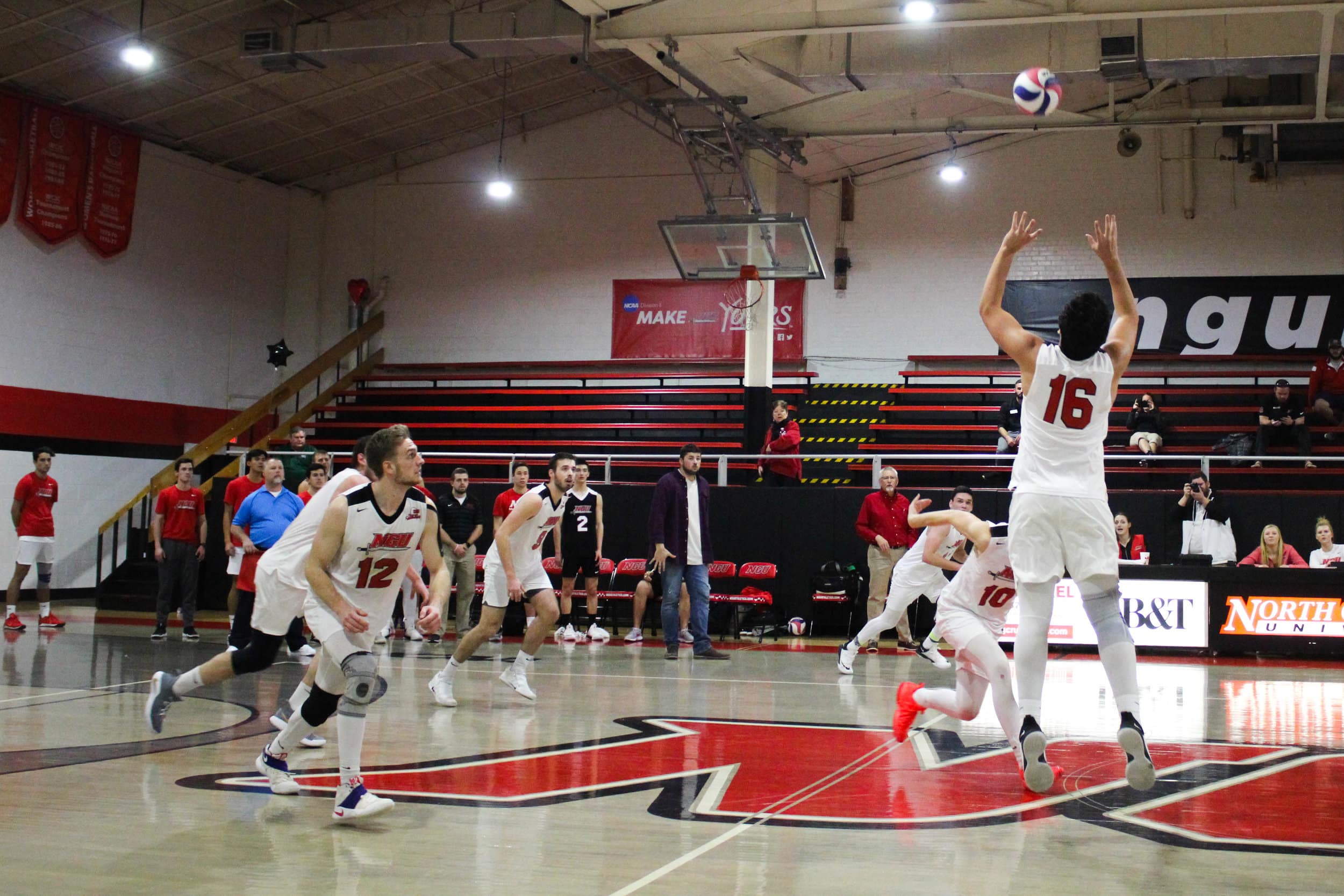 Freshman Sergio Carrillo (16) sets the ball to sophomore Brandon Baker (10).