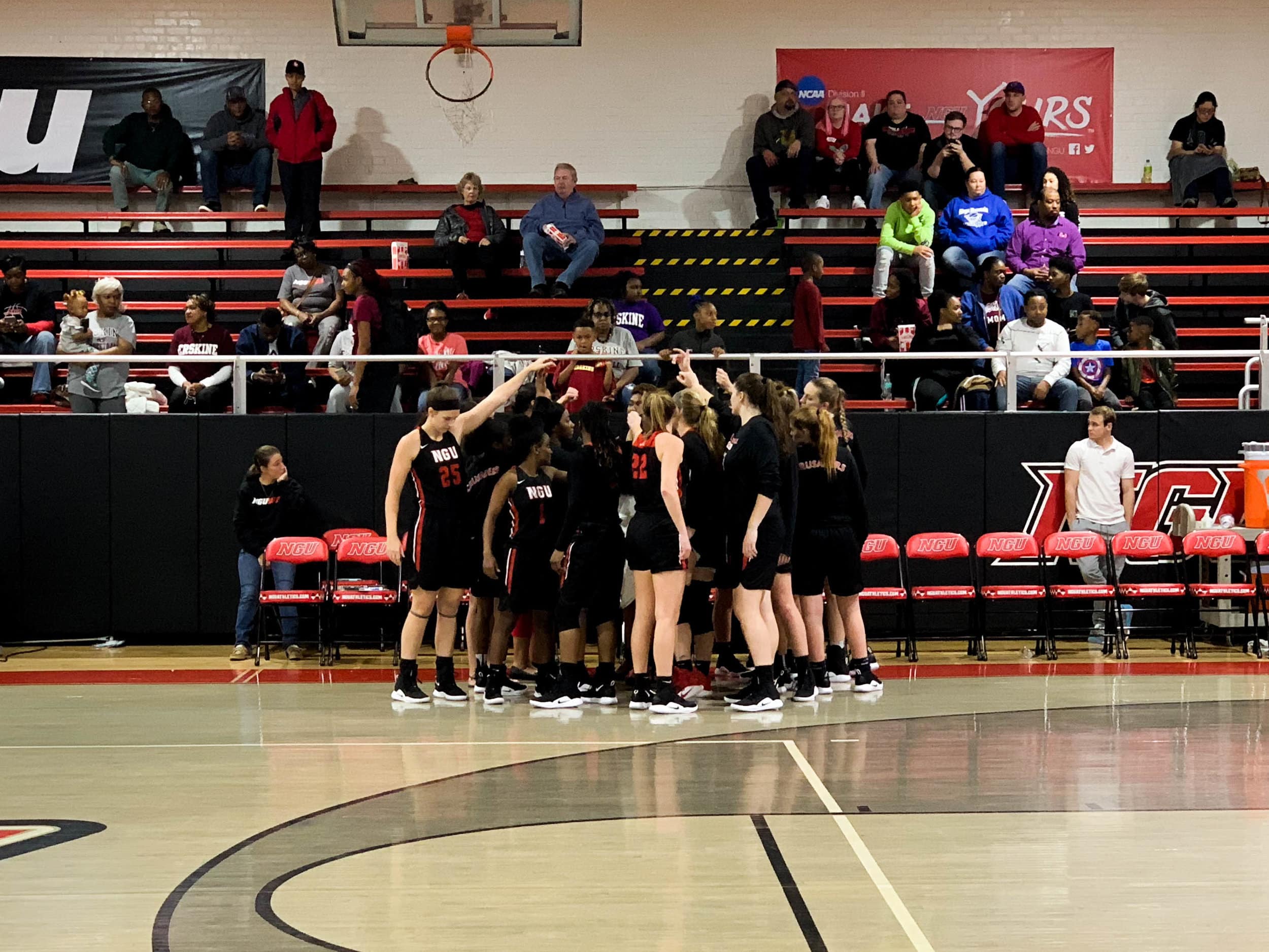 Before the game begins, the NGU team huddles together.