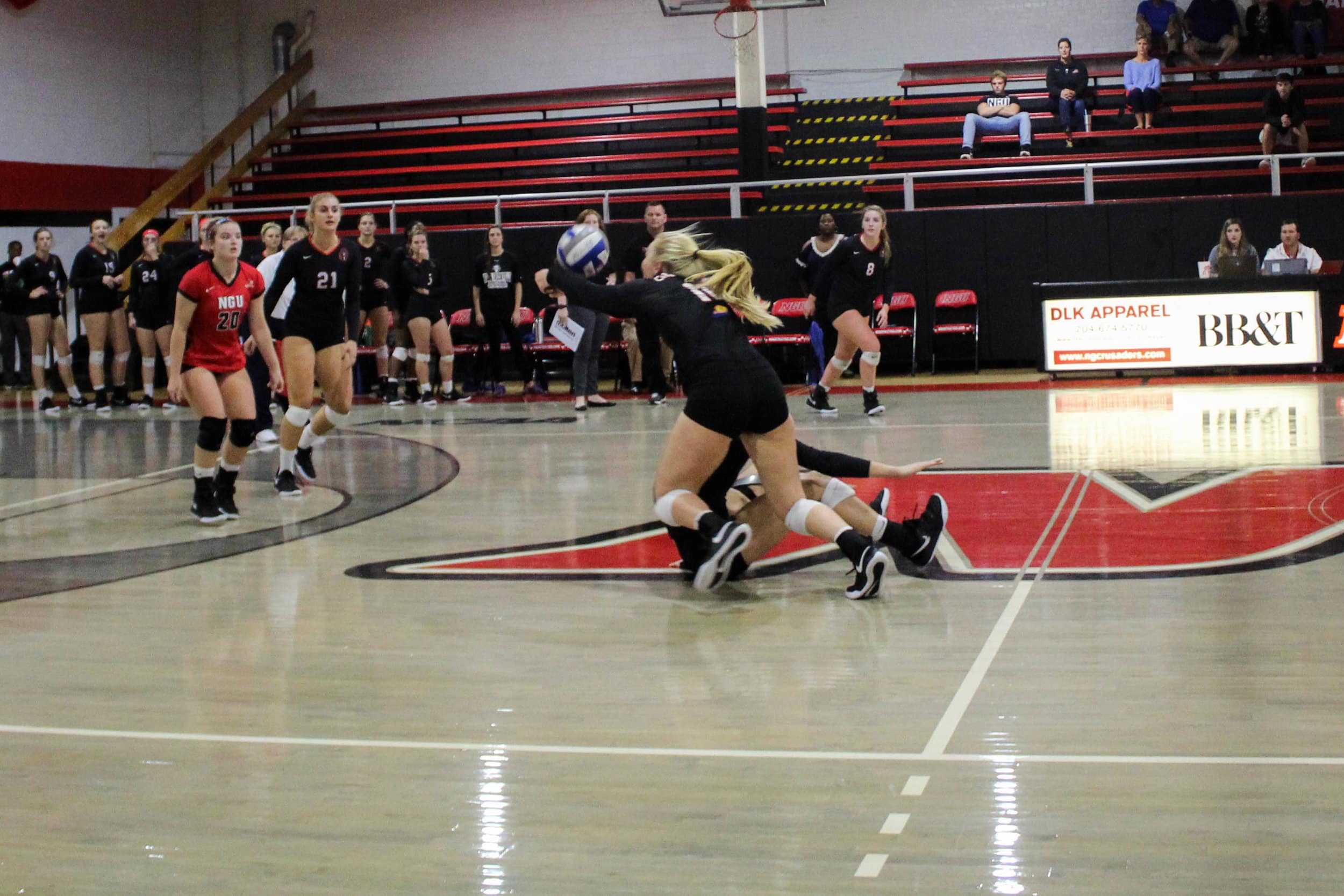 Senior Sara Miller (11) dives in hopes of hitting a ball hit toward her by a Limestone player.